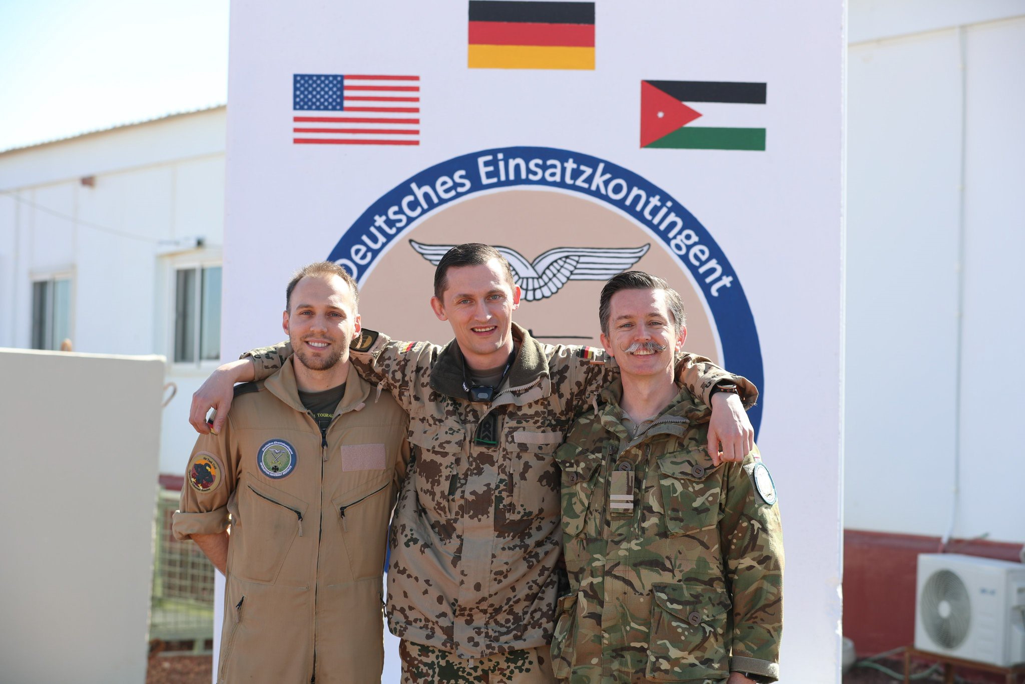 Three servicepeople standing for the camera.
