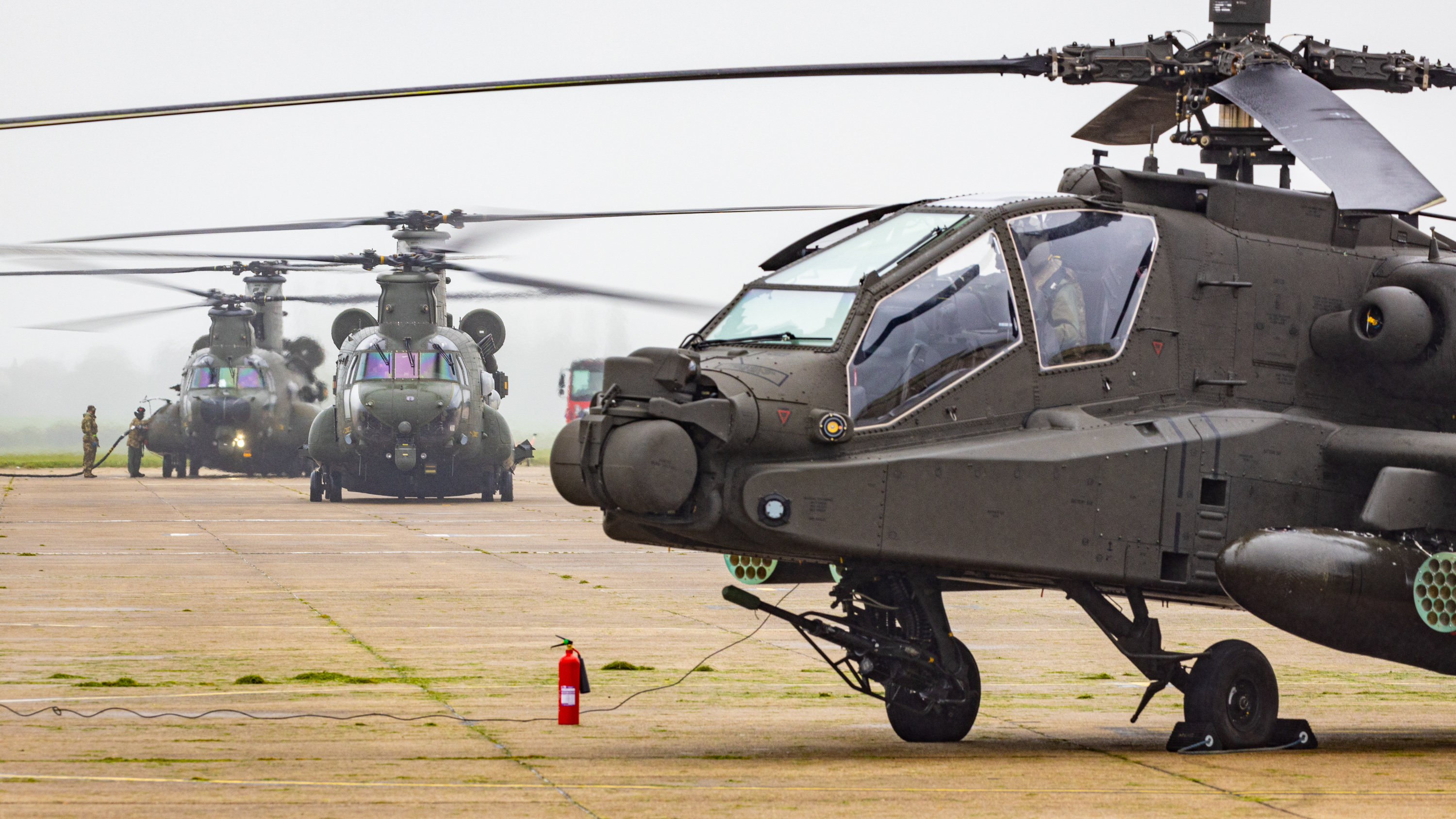 Image shows Apache Chinook helicopters.