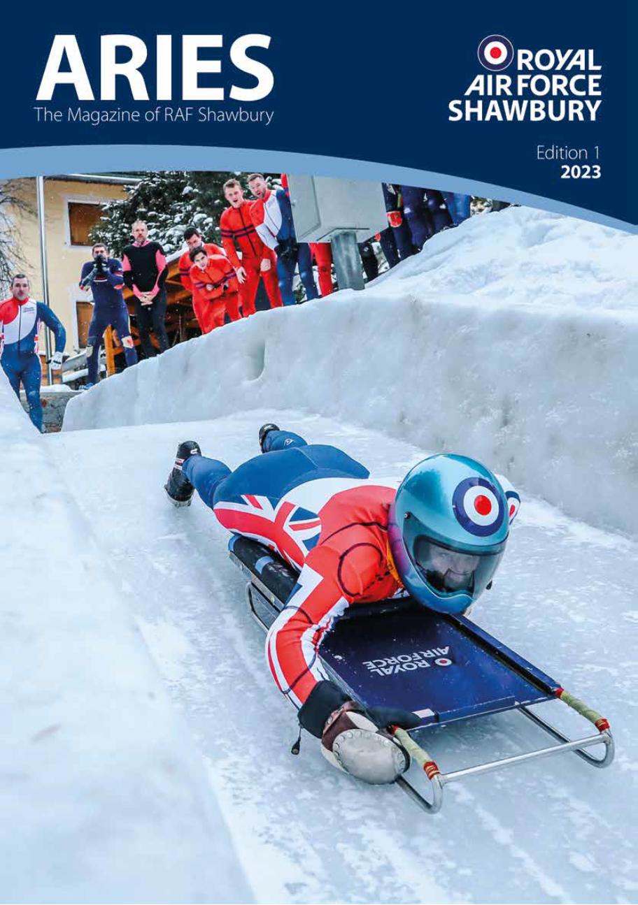 Image shows front cover of Aries magazine, of RAF personnel running a luge snow ski.course.