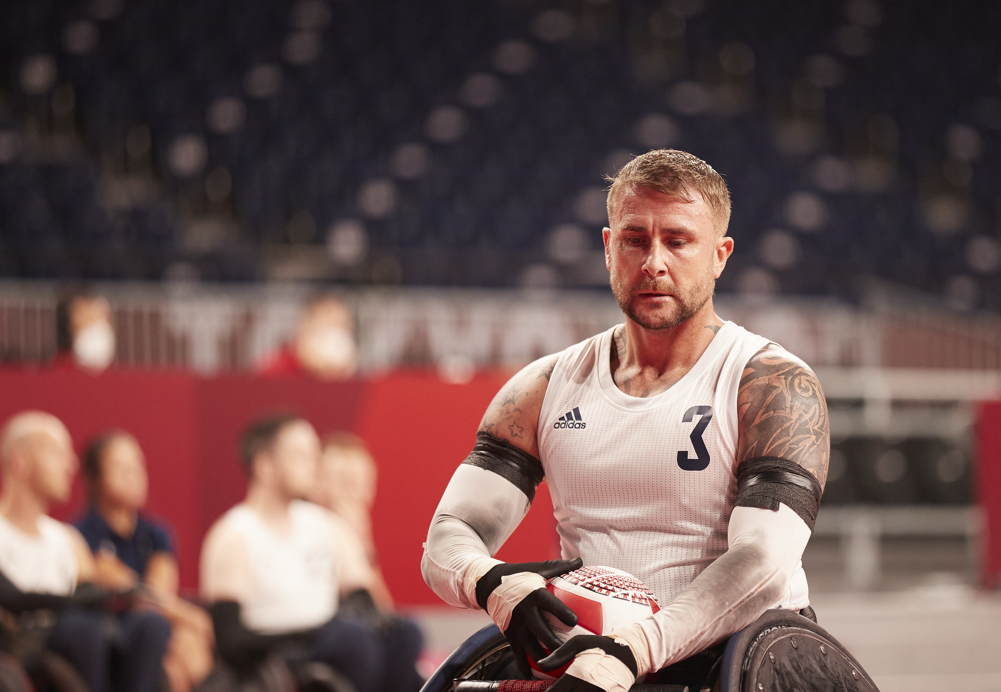 Wheelchair rugby player holding the ball.