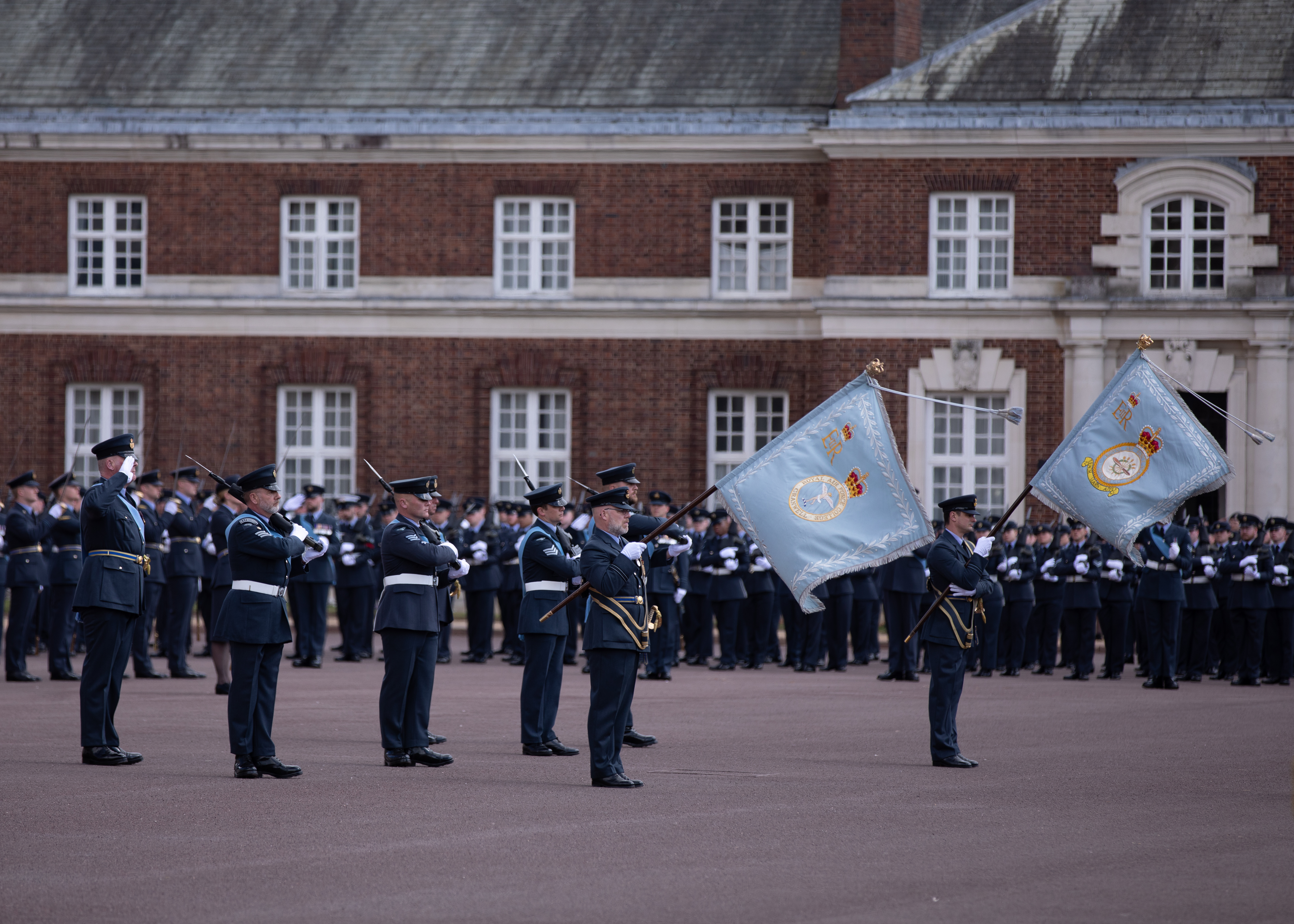 Personnel on parade with Colour flags.