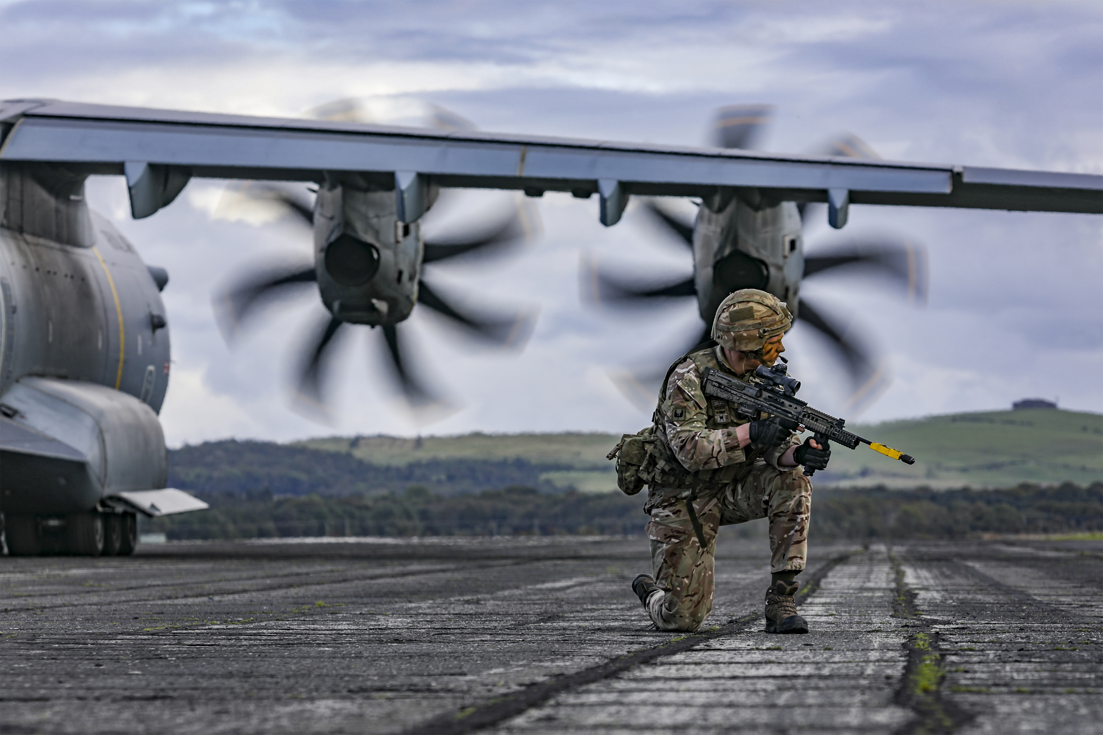 Atlas propellers, with RAF Regiment soldier kneeling with his rifle.