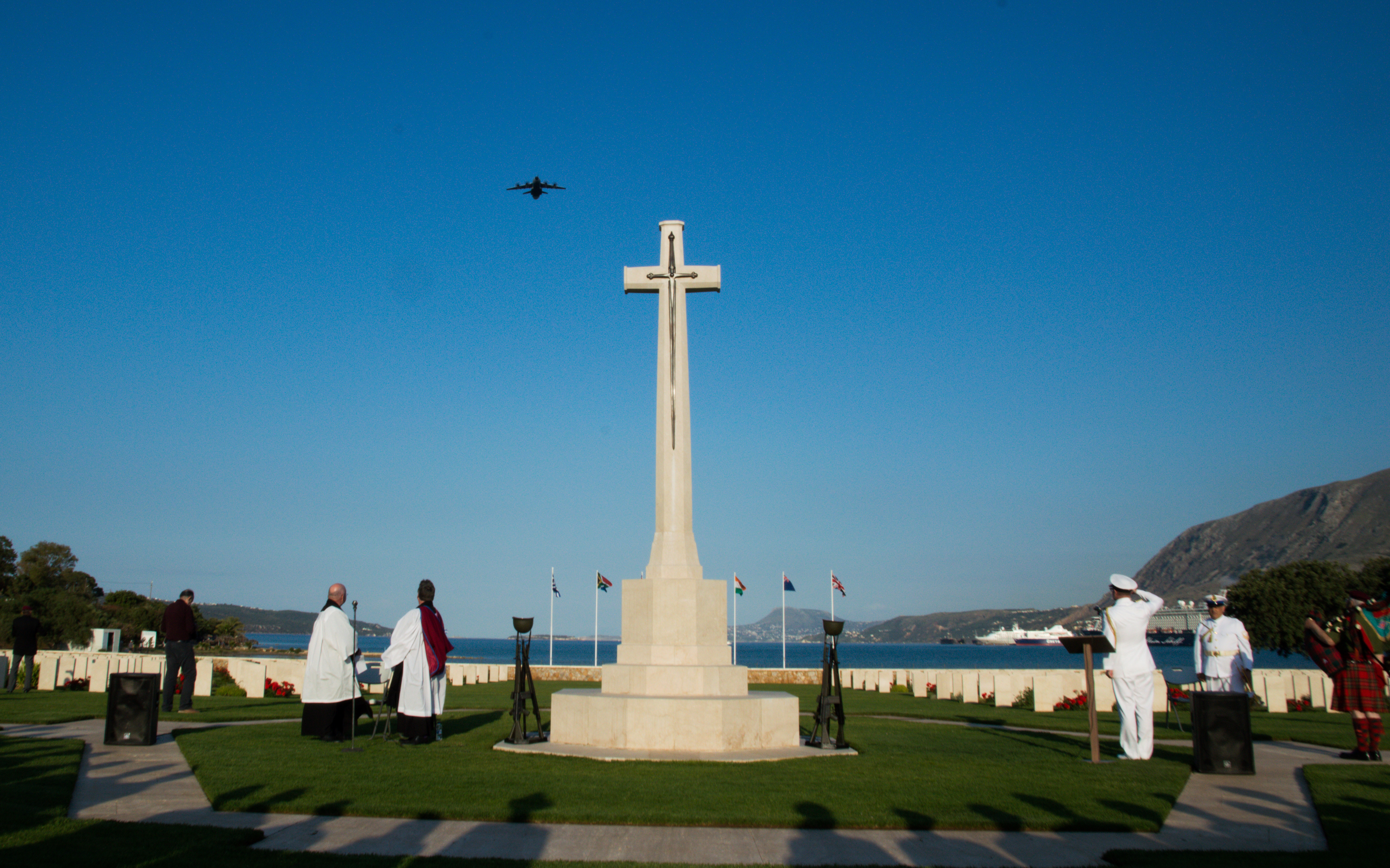 Personnel stand by memorial with flypast.