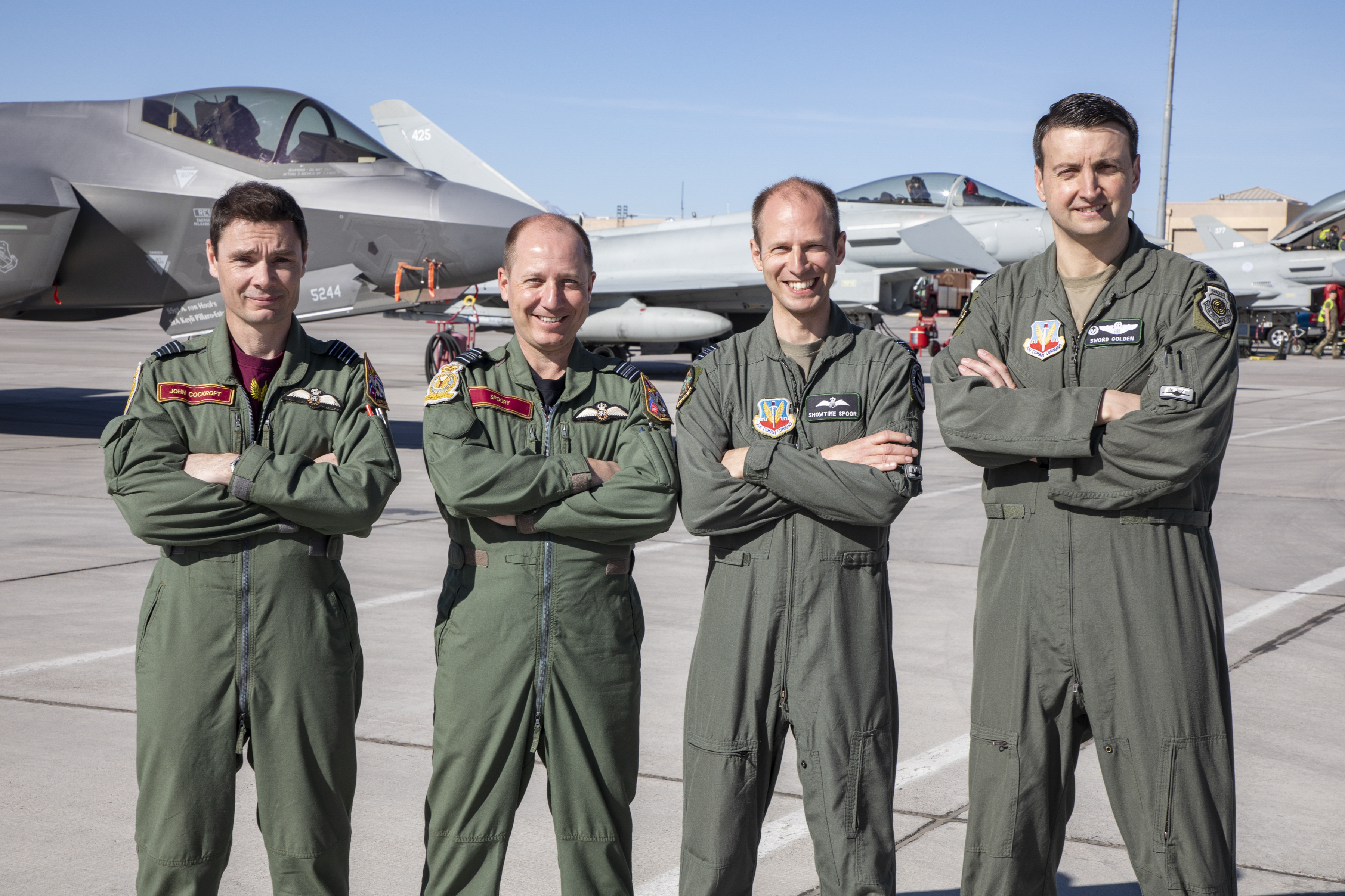 Four RAF Pilots on the airfield with Typhoons behind them.