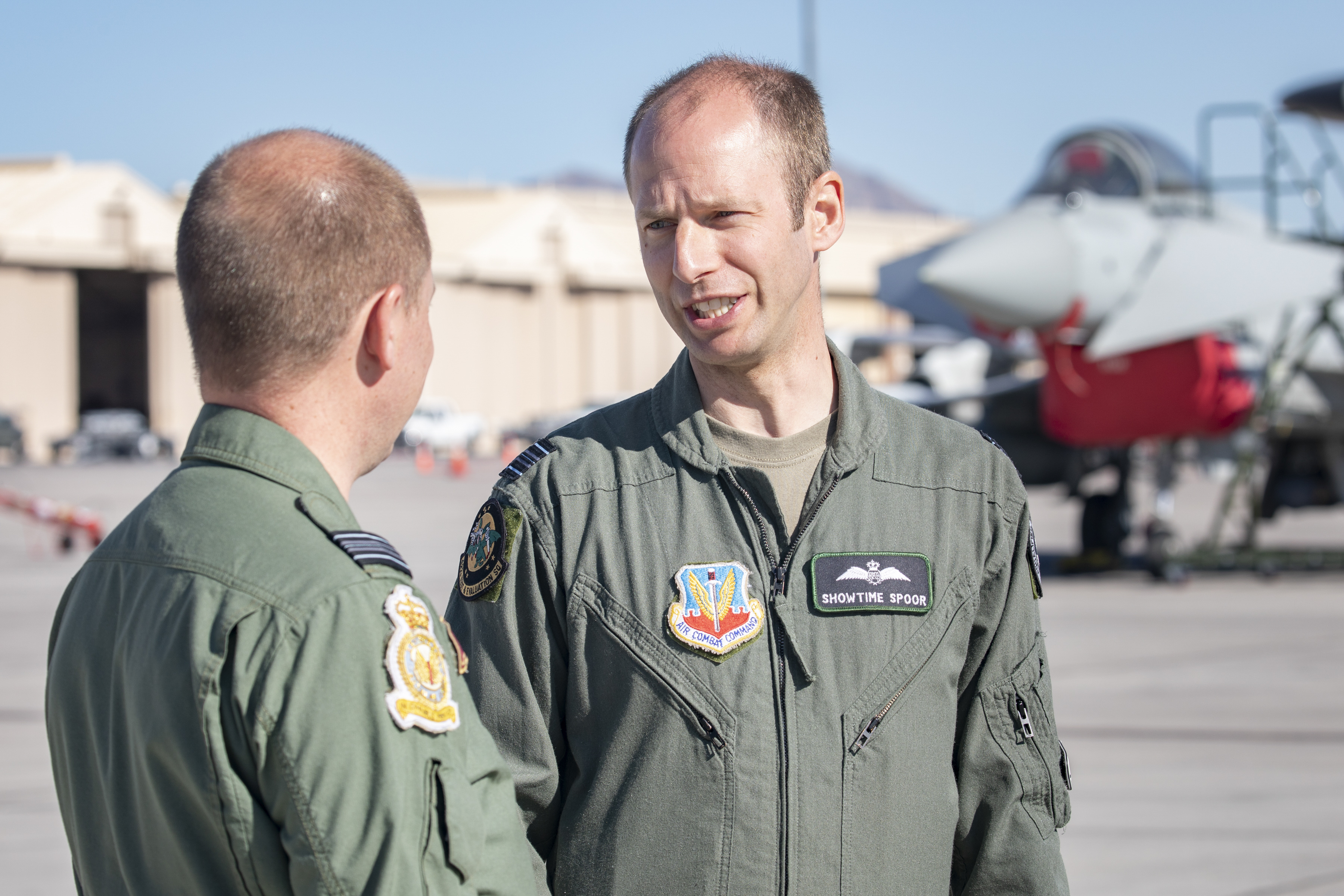 Two RAF Pilots on the airfield with Typhoons.