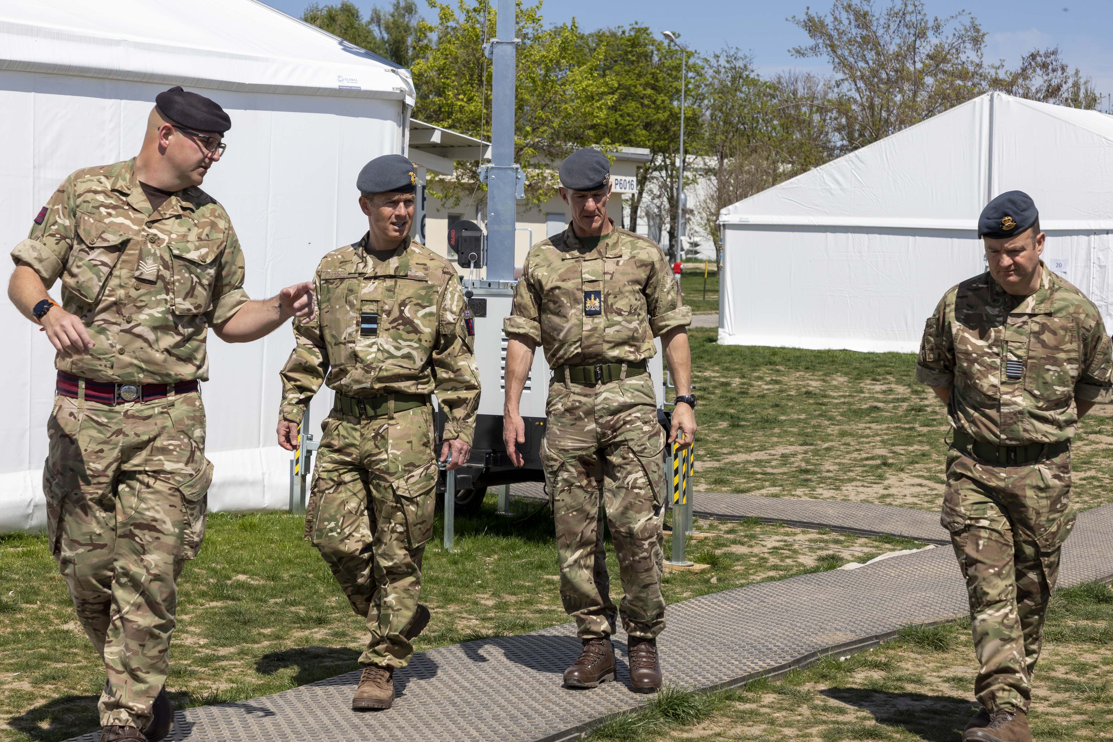 RAF Personnel walking by temporary buildings.
