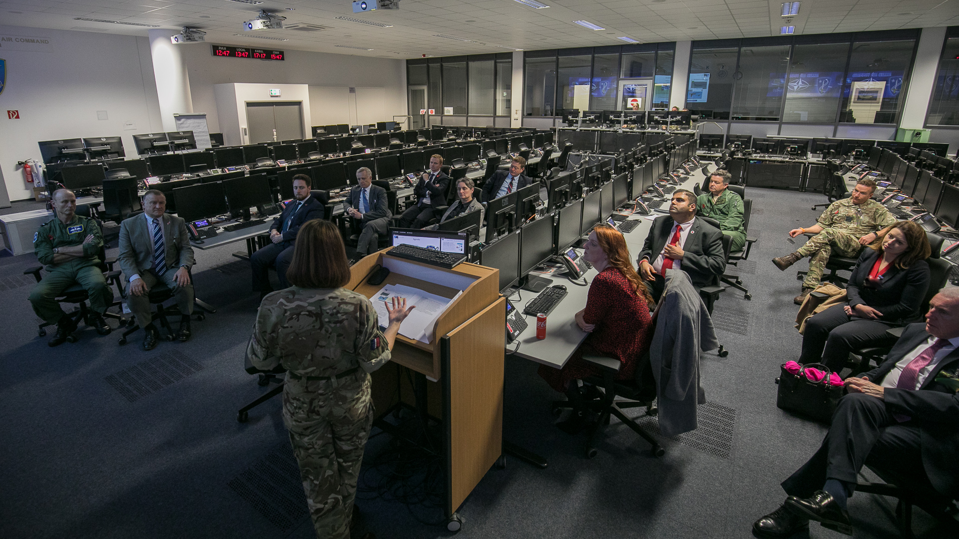 Personnel sit on chairs with computers.