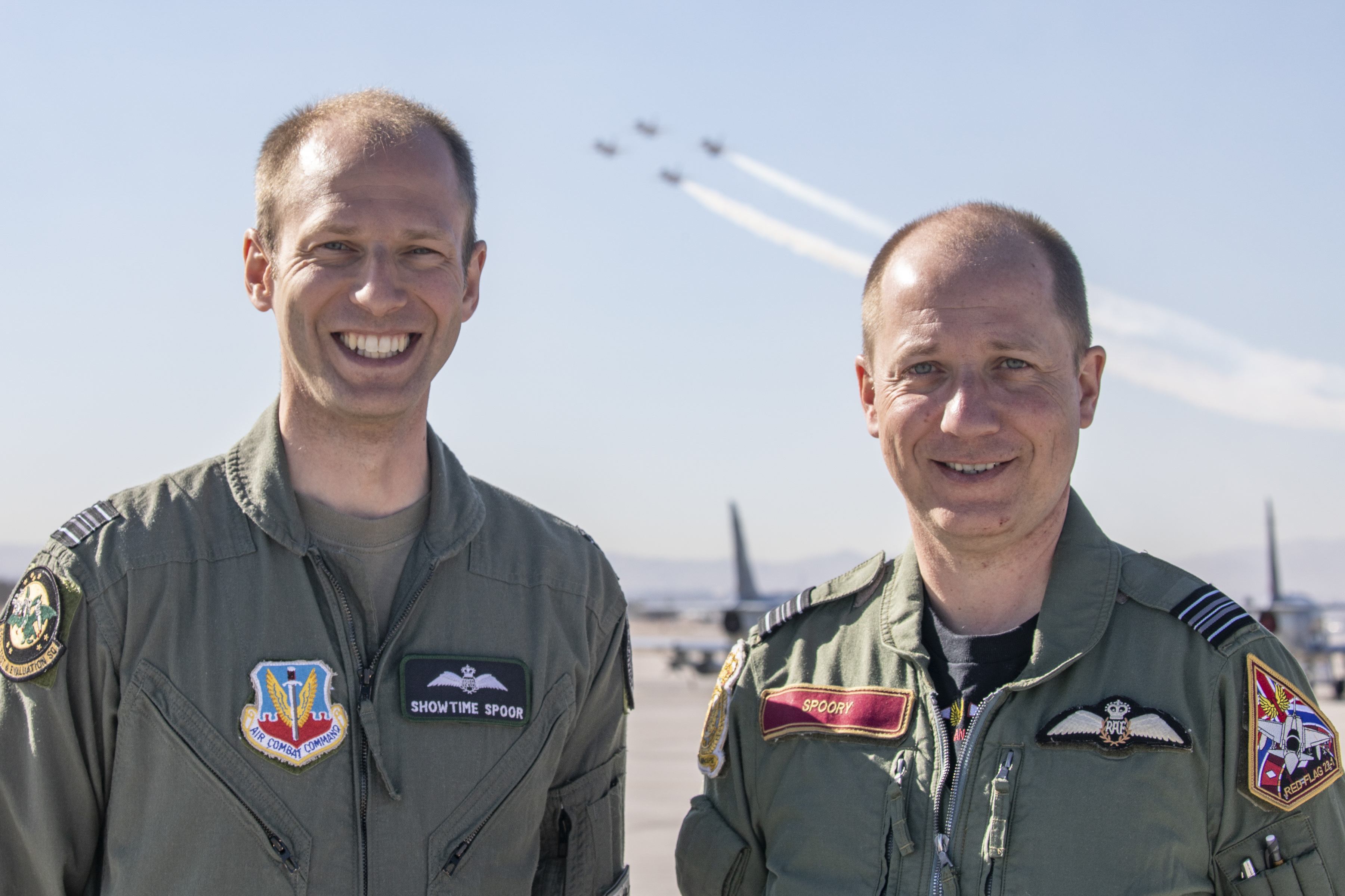 Two RAF Pilots, with Typhoon's flying past behind them.