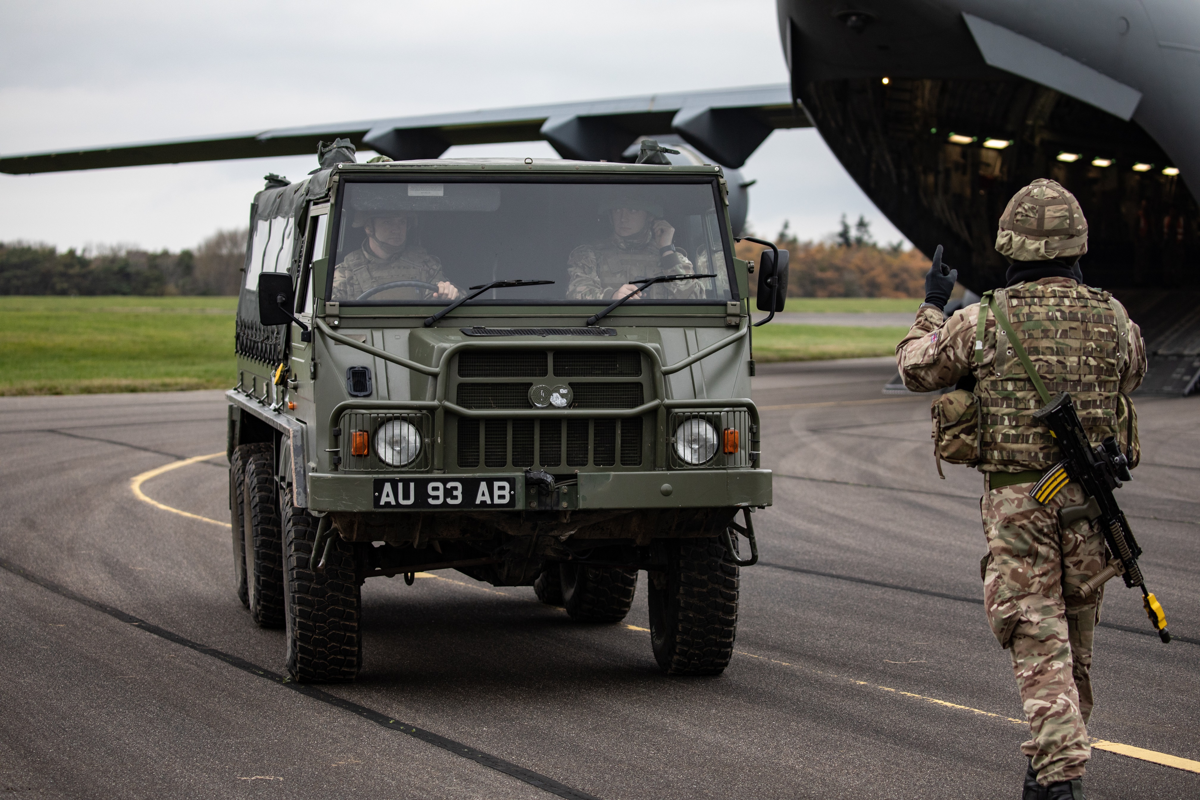 Personnel from No 1 Air Mobility Wing loading personnel and equipment from No 16 Air Assault Brigade onto a 99 Squadron RAF C-17
