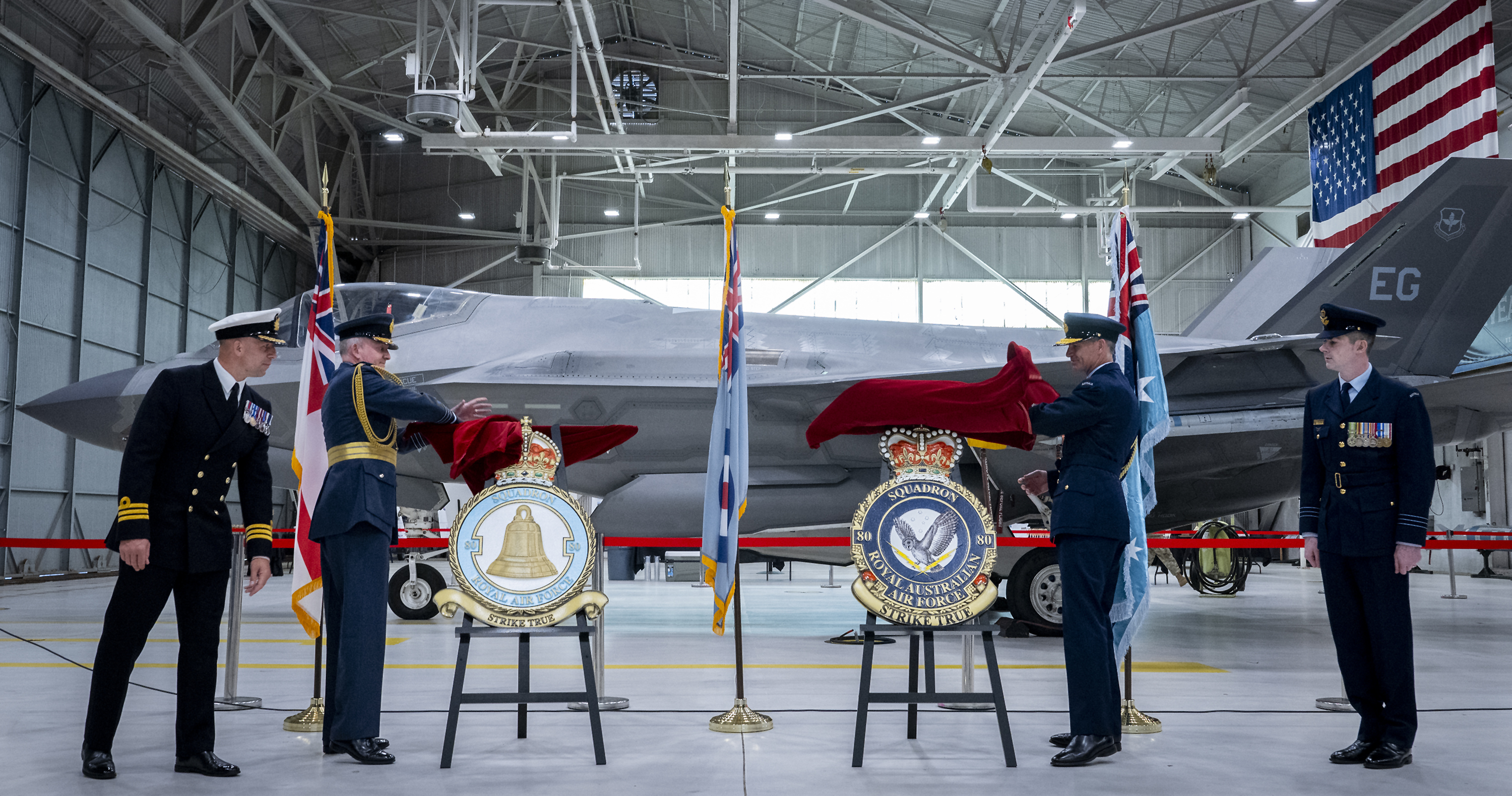 Personnel unveiling the new squadron badges.