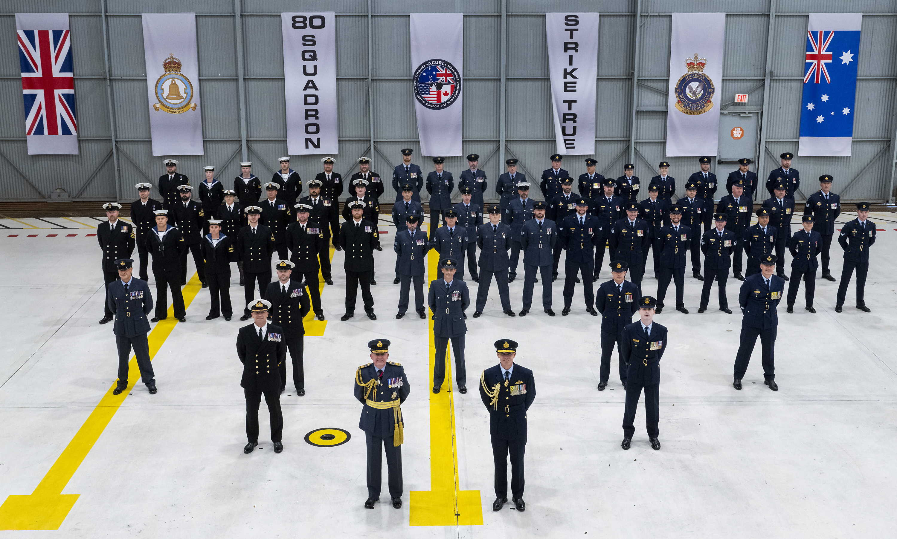 Group shot of personnel formed up in the hangar.