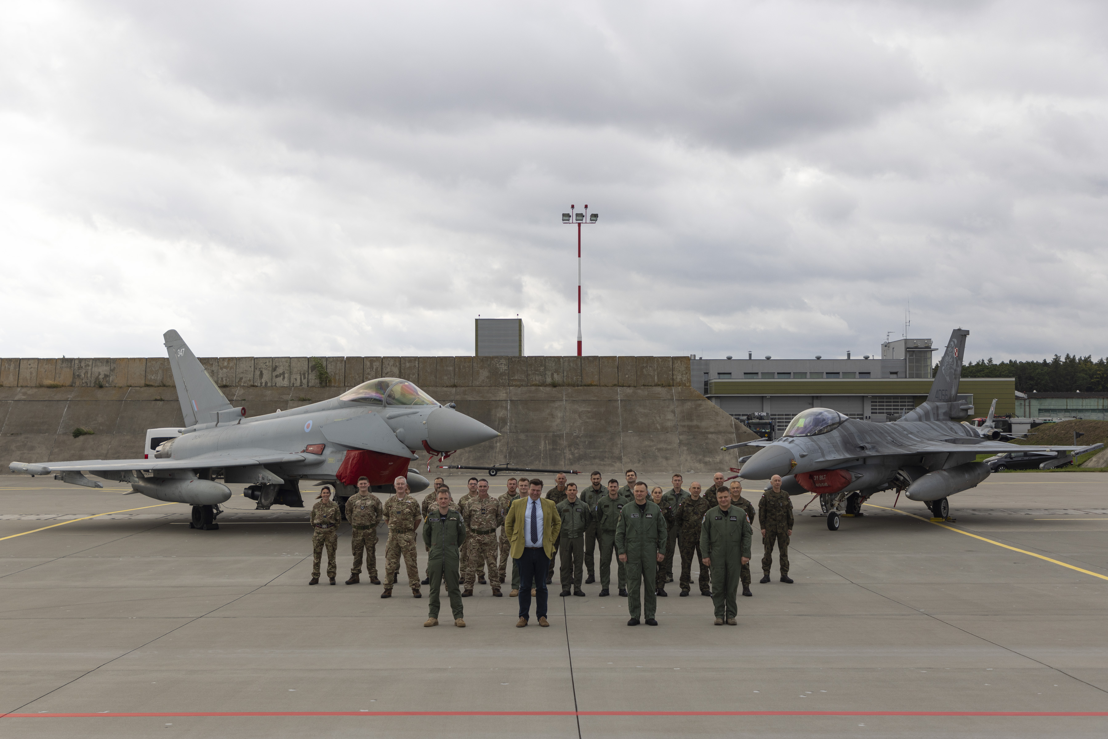 Defence Minister, Defence Attache and some of the Op Carson team, standing in front of a RAF typhoon and a Polish aircraft