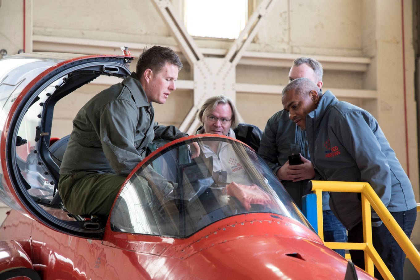 Members of the Virtual Red Arrows team talking with the Red Arrows groundcrew.