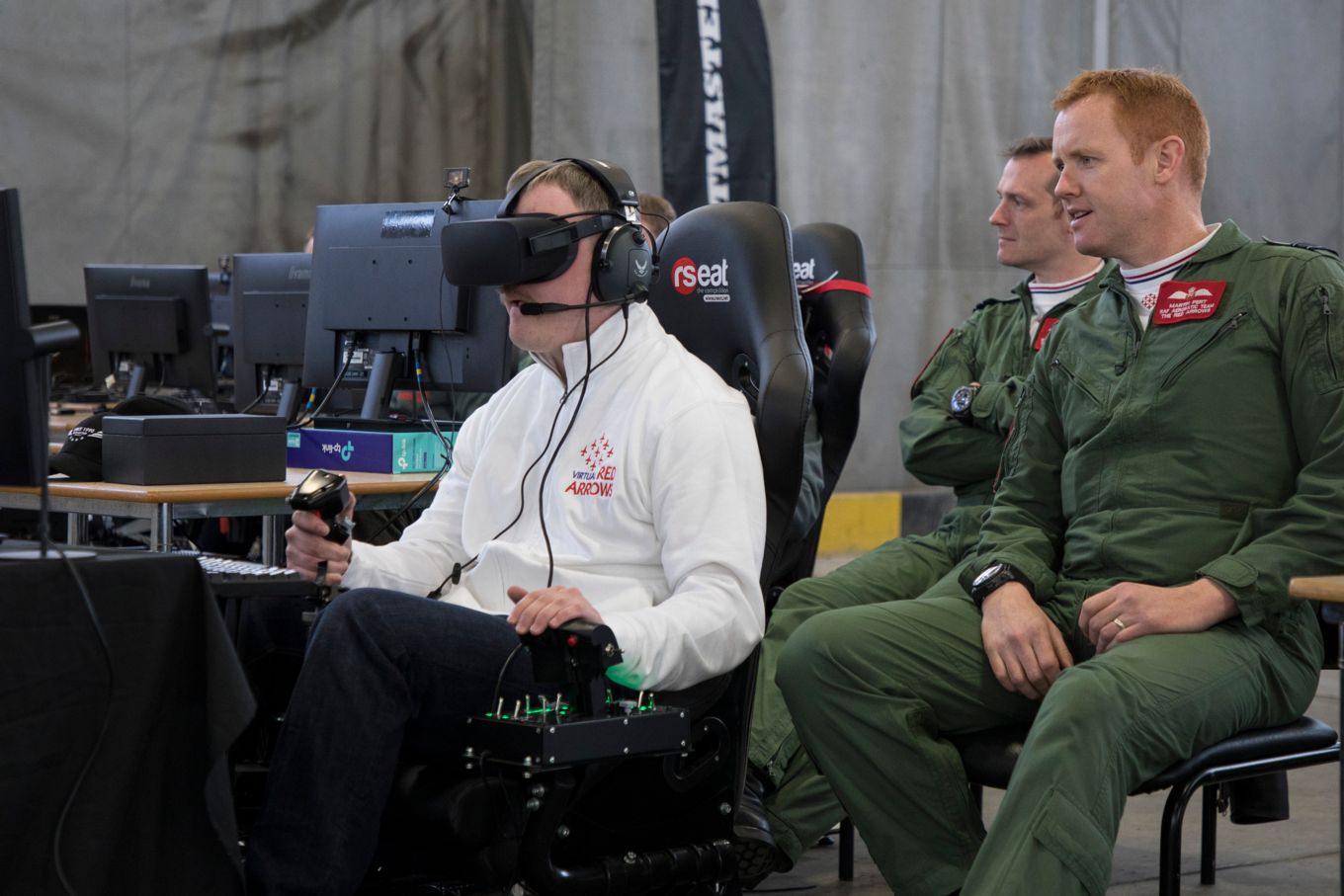 Squadron Leader Martin Pert (Red 1) watching the Virtual Red Arrows Team Leader Petter Hovland from Norway.