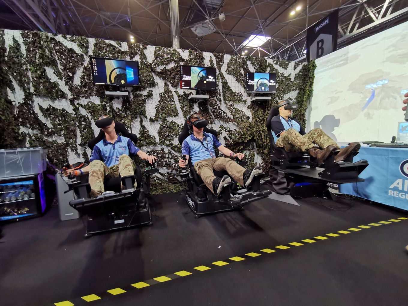 The RAF VGEA Team on flight simulators. Wing Commander Penter is far right