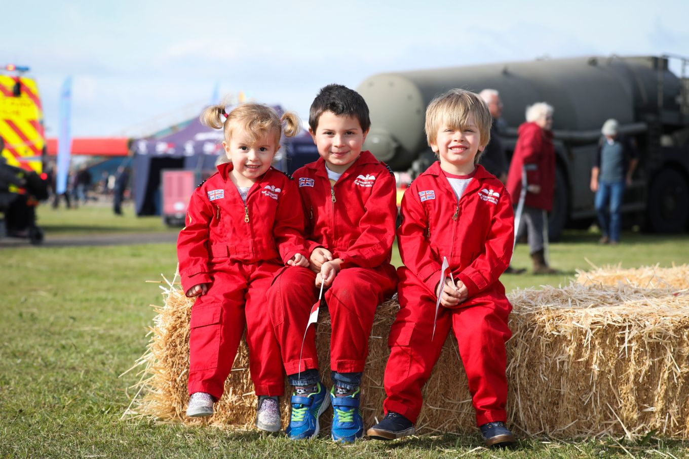 Three children in Red Arrow Suits