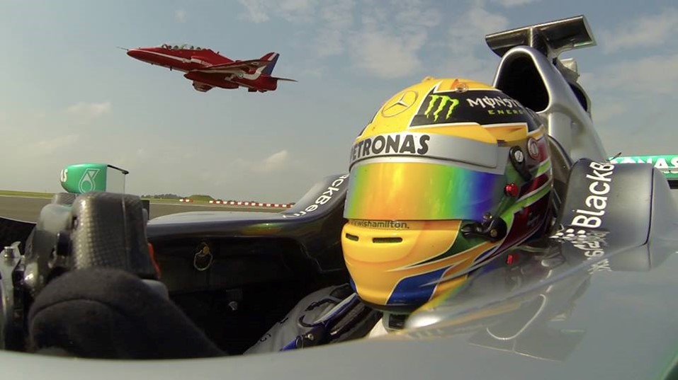 Squadron Leader Mike Ling, in the jet, flies above Lewis Hamilton's Mercedes in 2013.