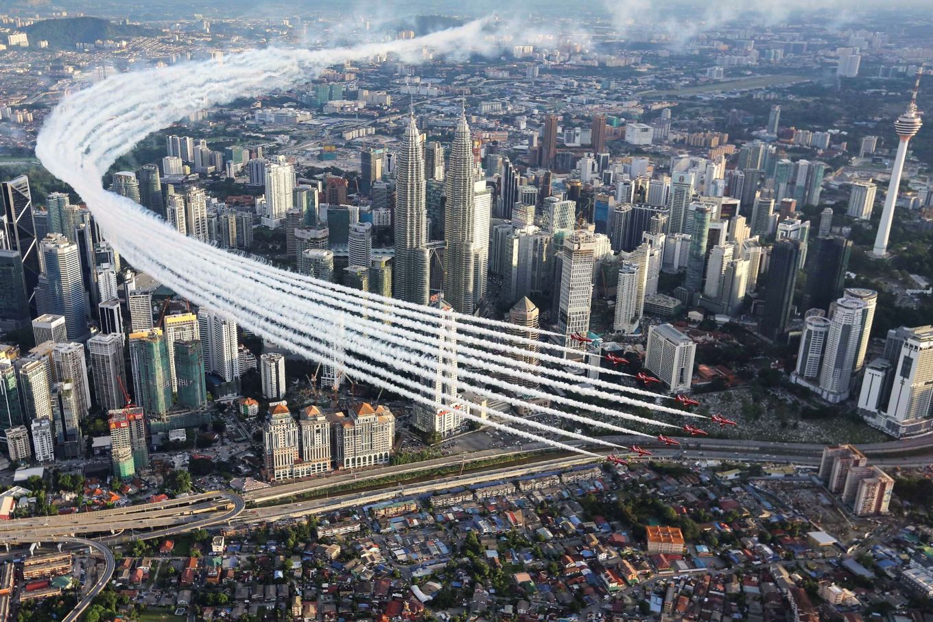 The Red Arrows perform a flypast of the Petronas Twin Towers in Kuala Lumpur, Malaysia, in 2016.