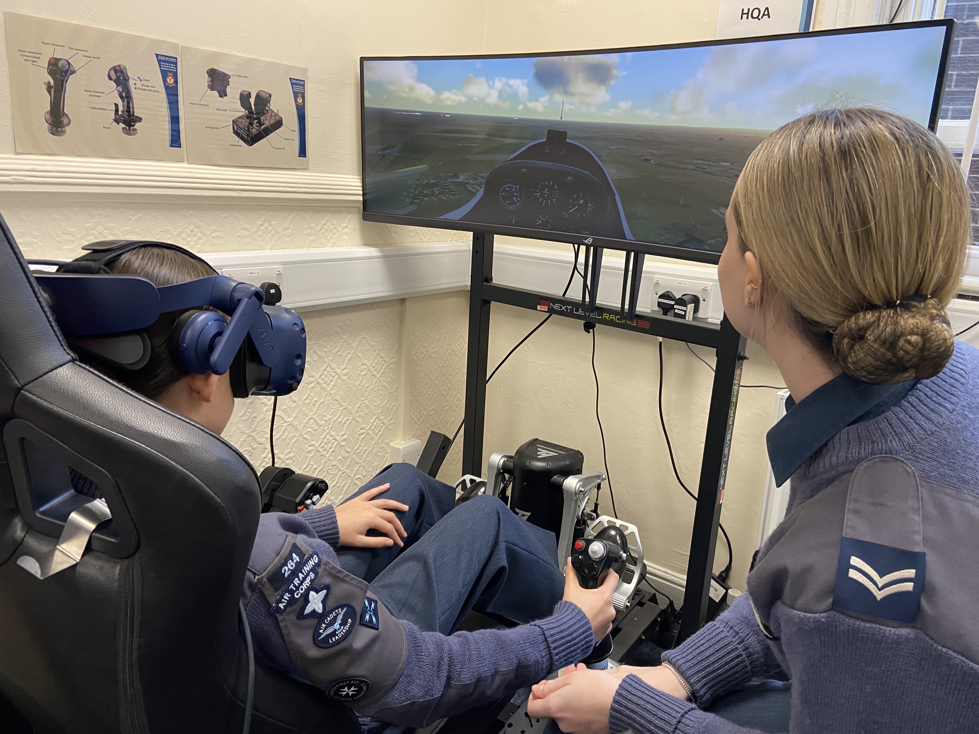 Two Air Cadets using a virtual reality simulator