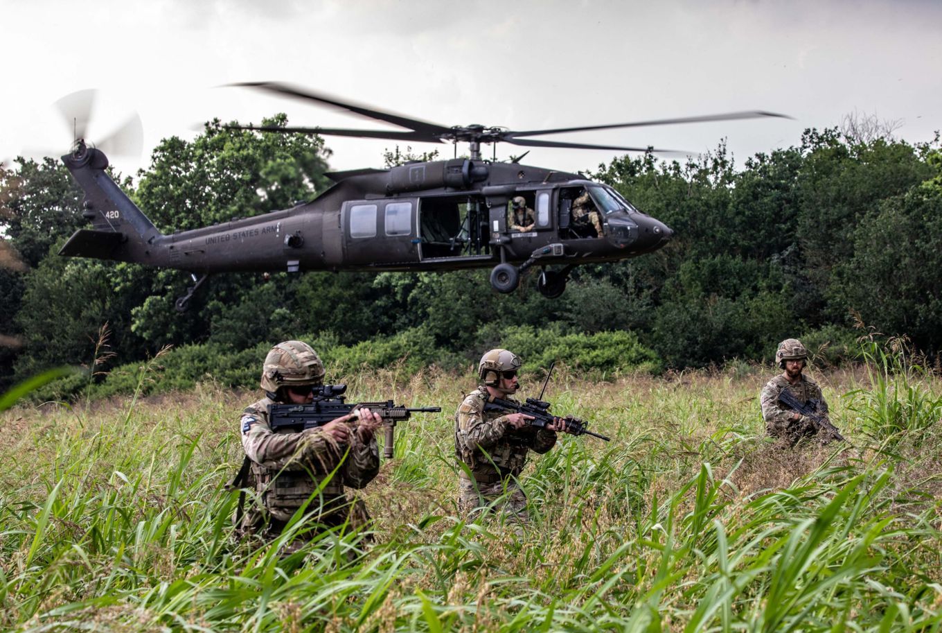US Army Black Hawk helicopter and three RAF Regiment Gunners.