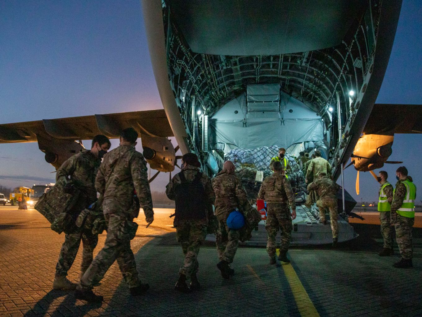Image shows military personnel boarding an RAF A400M aircraft from the rear.