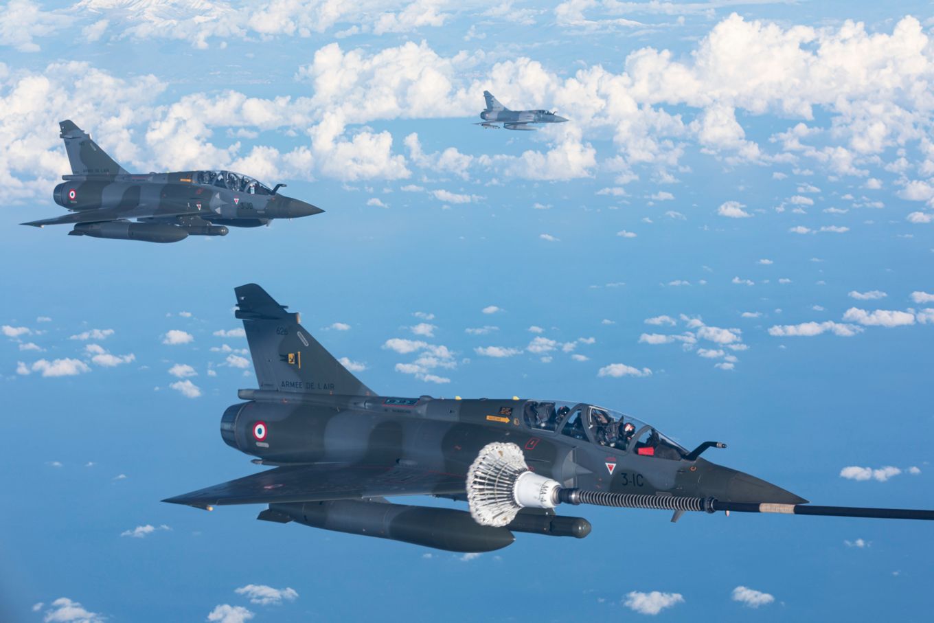 Image shows three French Mirage 2000 aircraft flying.