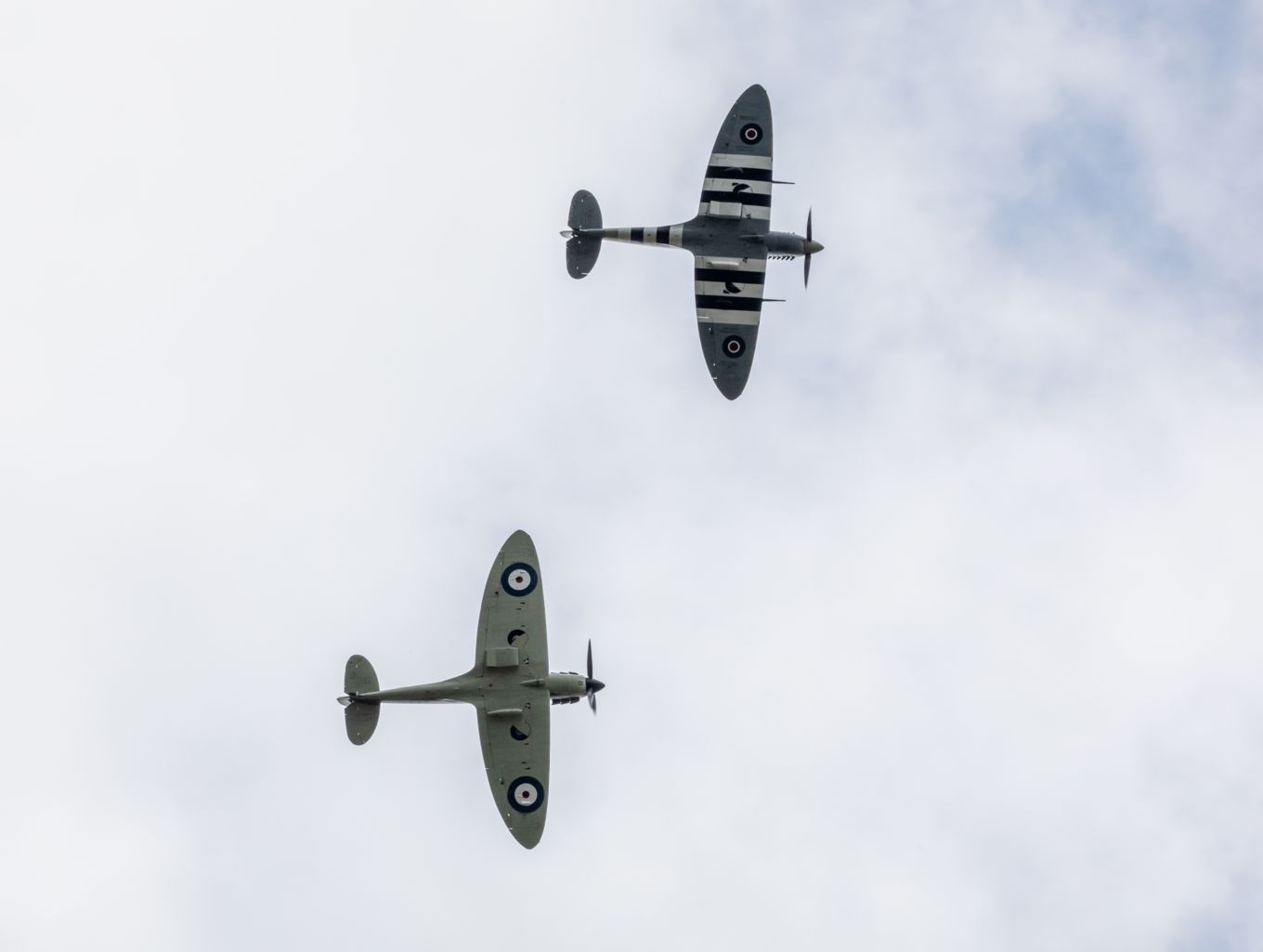 Image of two Spitfire aircraft from the RAF Battle of Britain Memorial Flight flying over Dame Vera Lynn's funeral