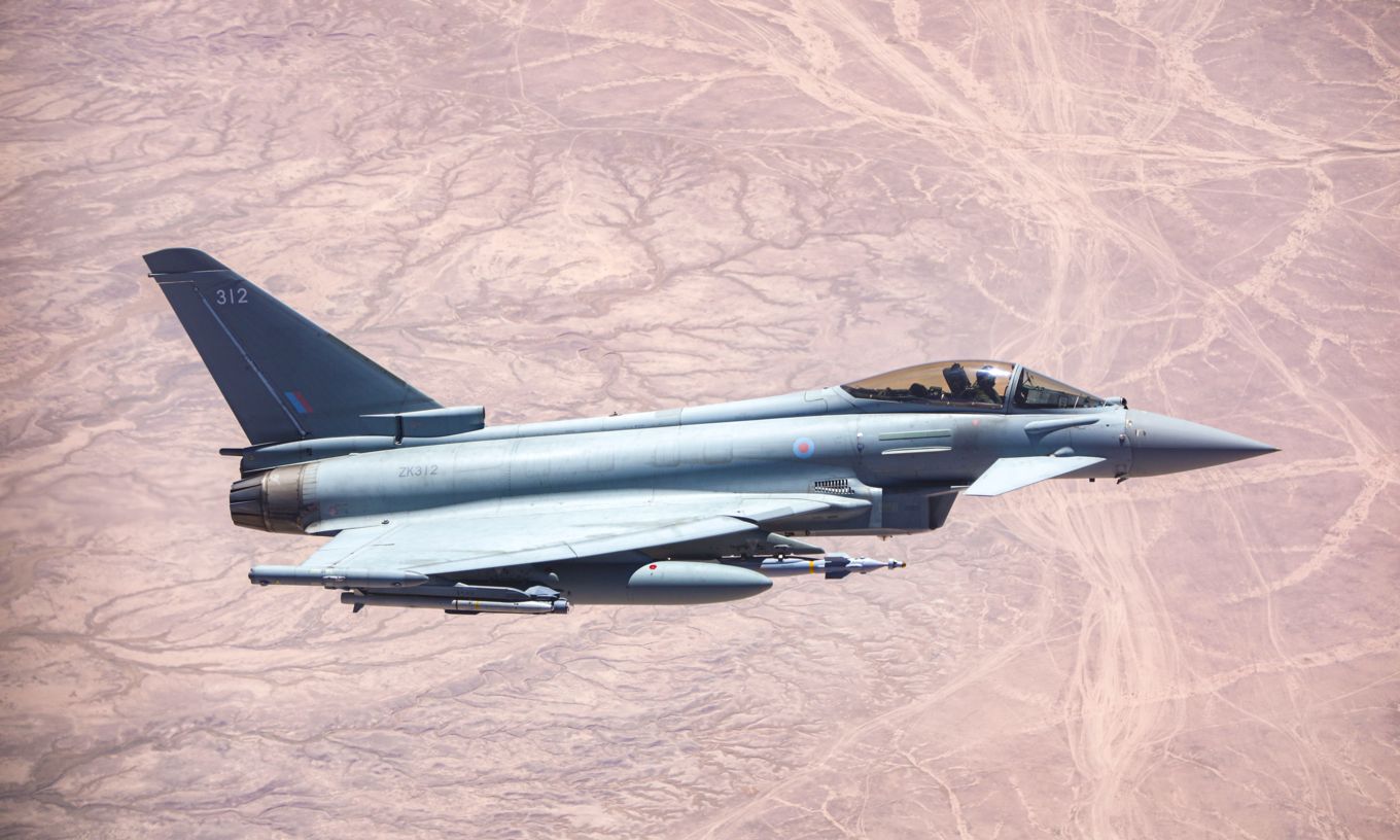 Image shows an RAF Typhoon aircraft flying above the desert.