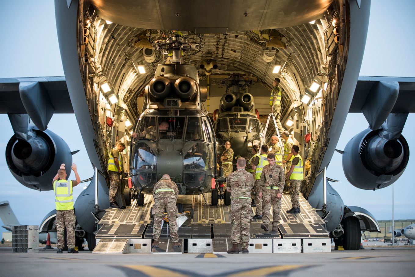 Image shows an RAF C-17 aircraft with two helicopters inside.