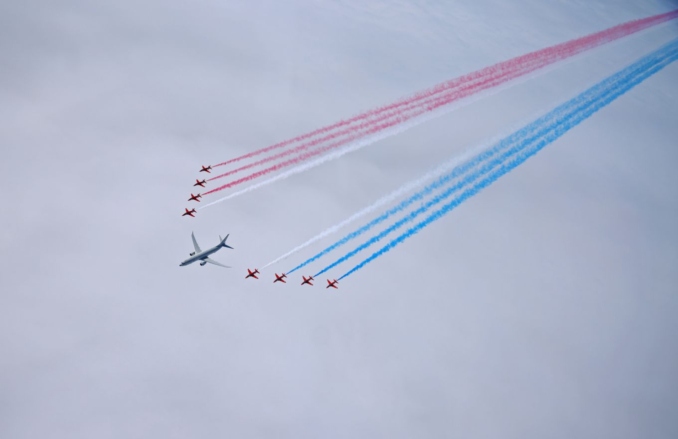 Red Arrows in formation with Poseidon and Union Jack smoke trails.