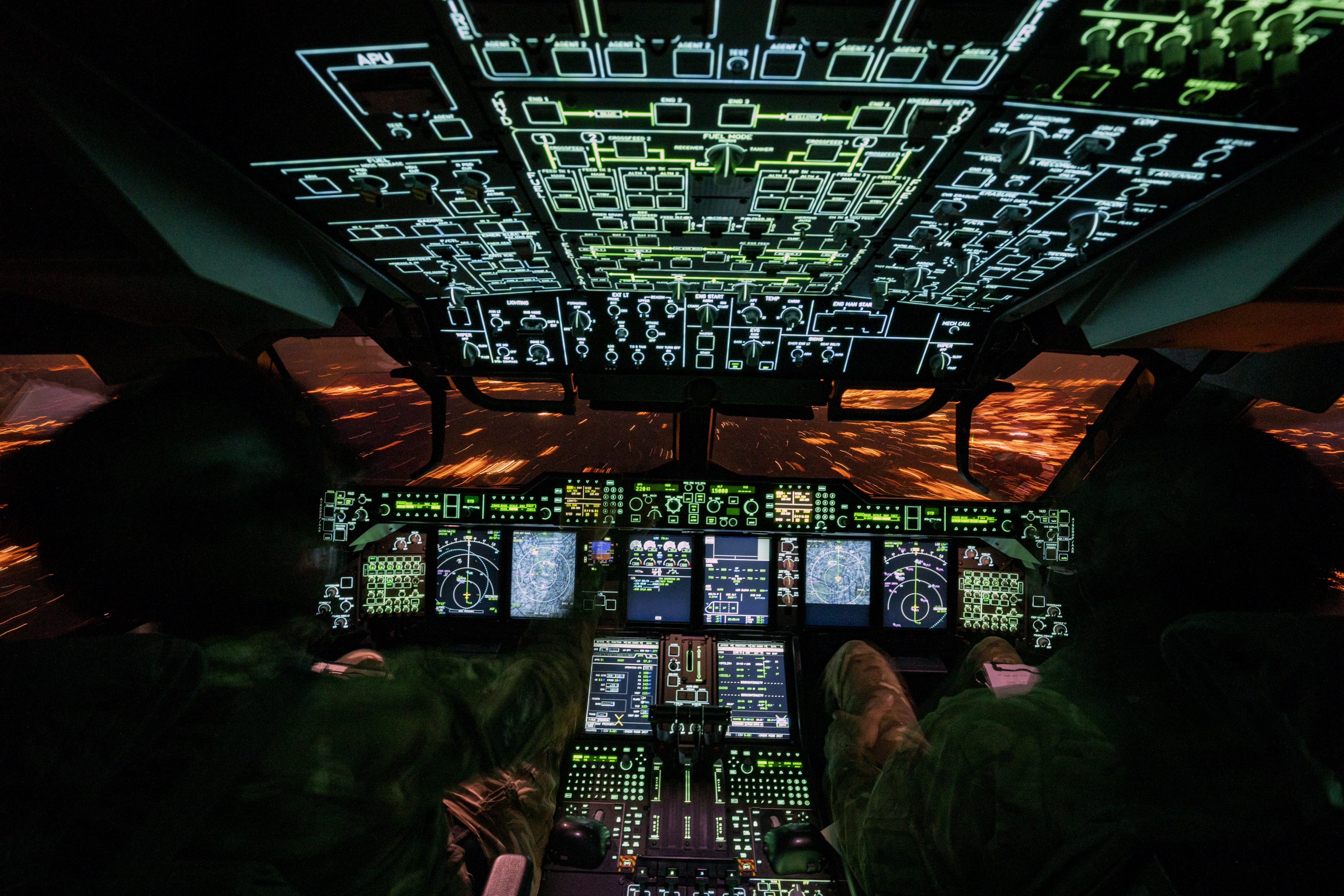 Inside the cockpit at night, with all instruments lit up.