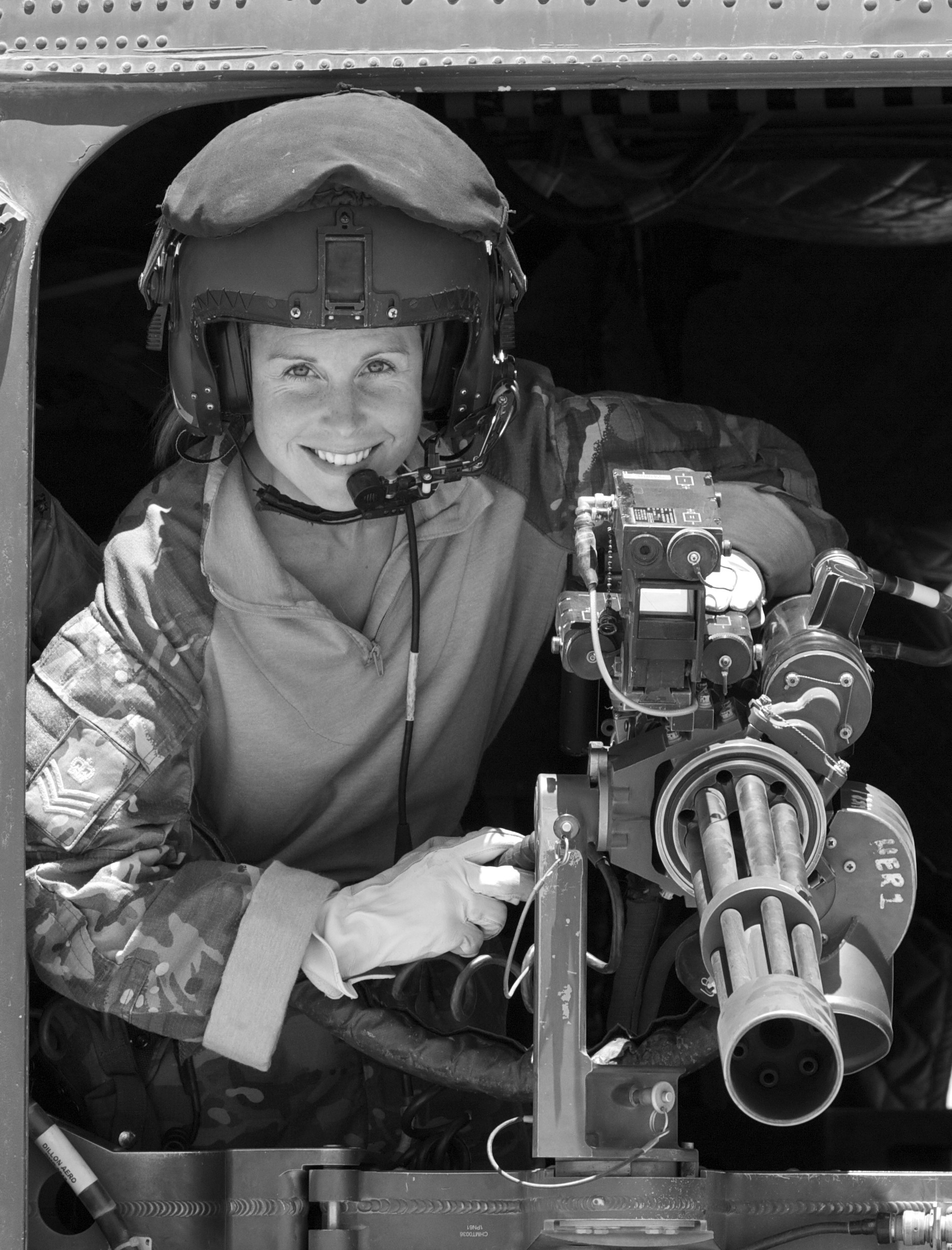 black and white image of Liz on a chinook wearing crew kit. 