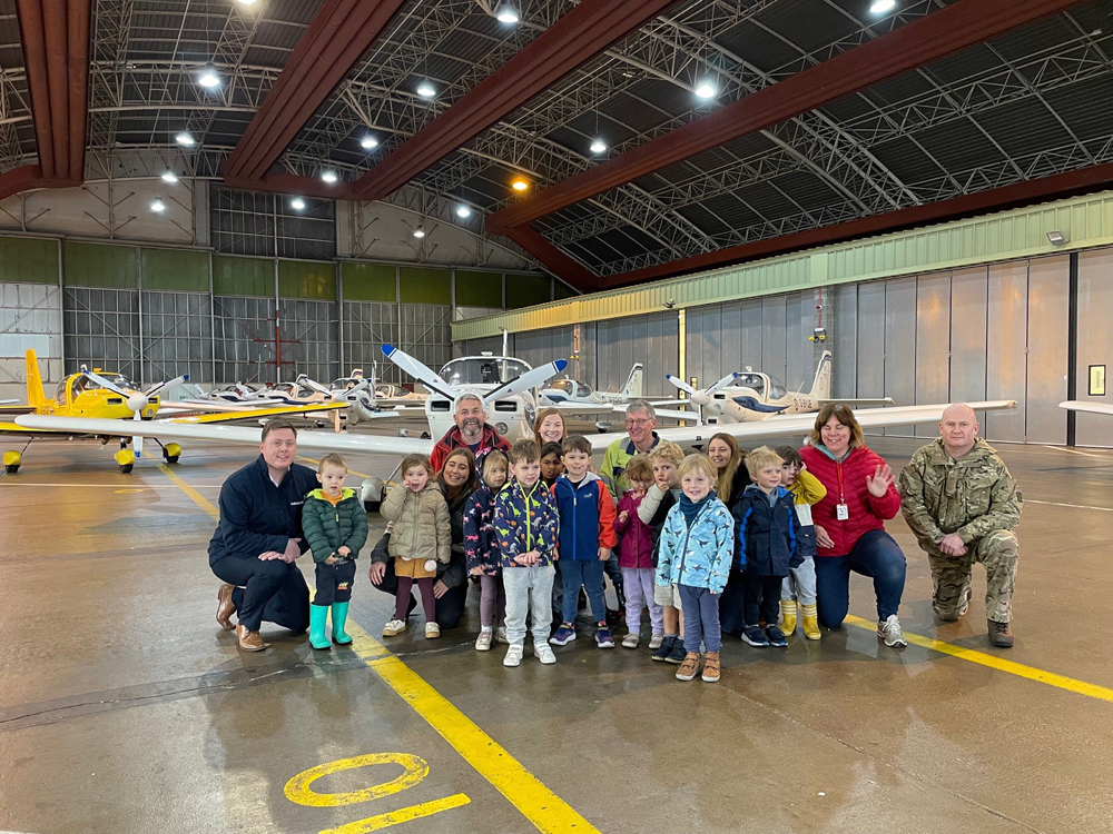 Children from the nursery in front of an aircraft
