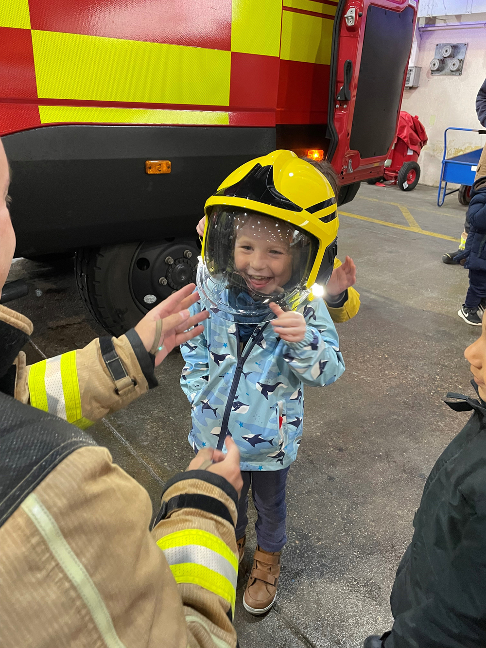 A budding firefighter tries on a helmet during a visit at RAF Wittering