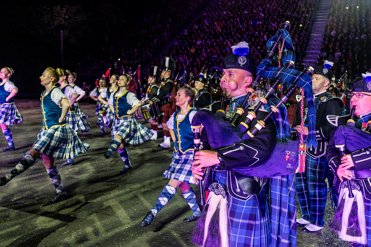 RAF pipes and drums performing at night with highland dancers