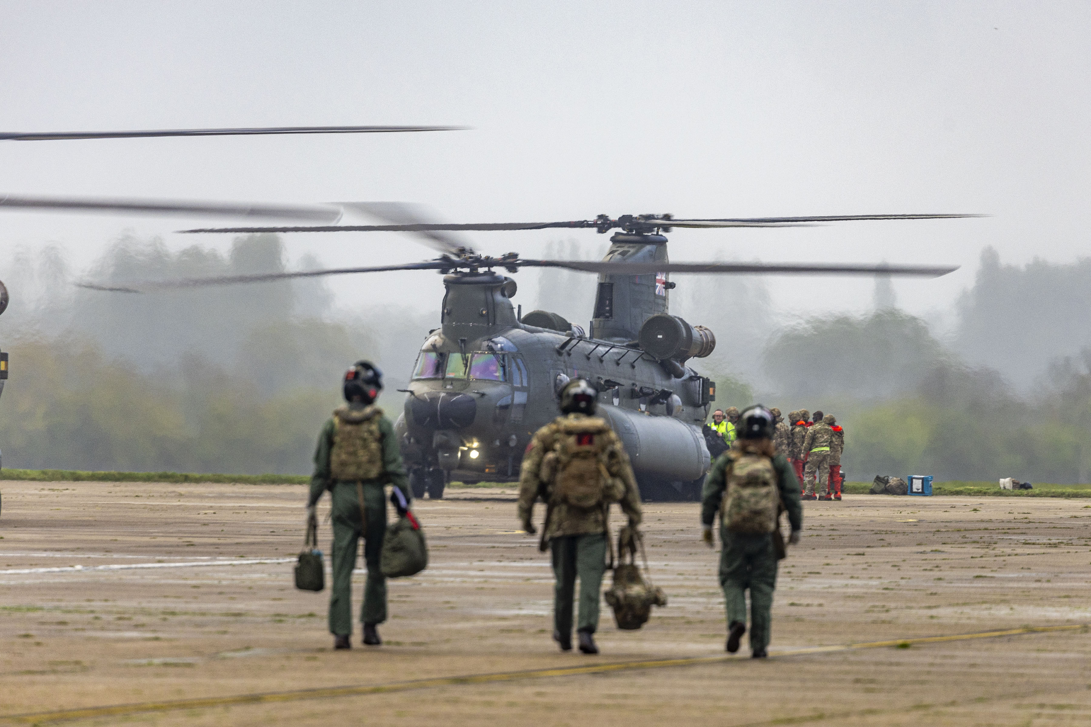 Image shows aircrew walking towards a Chinook helicopter.