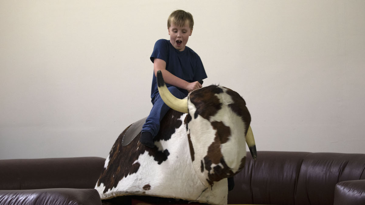 Young boy enjoys the bucking bronco