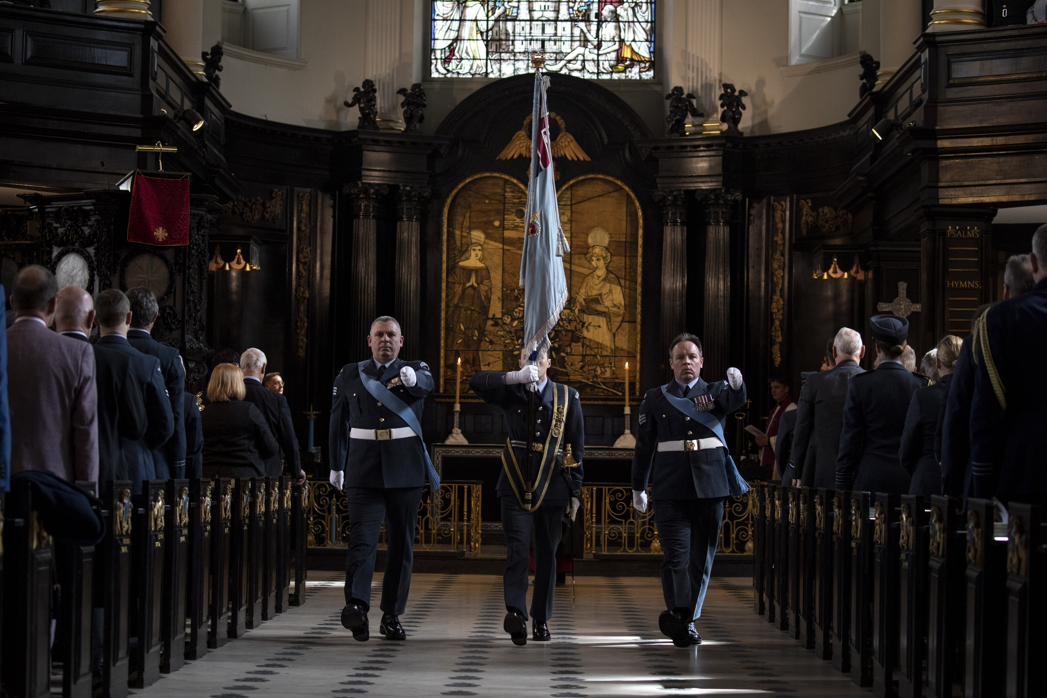 Personnel inside the church perform the service.