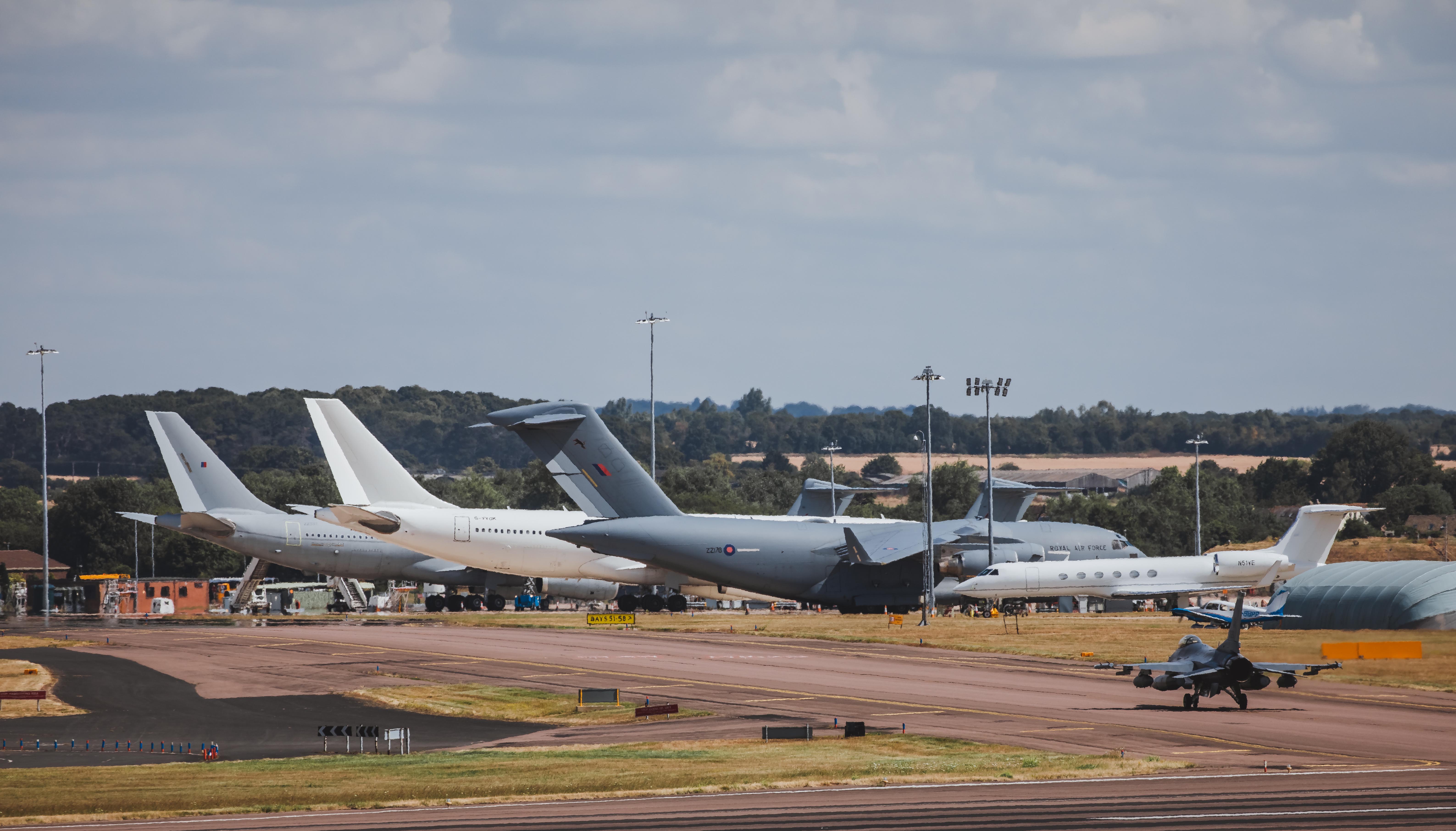 Image shows airfield with aircraft on the runway.