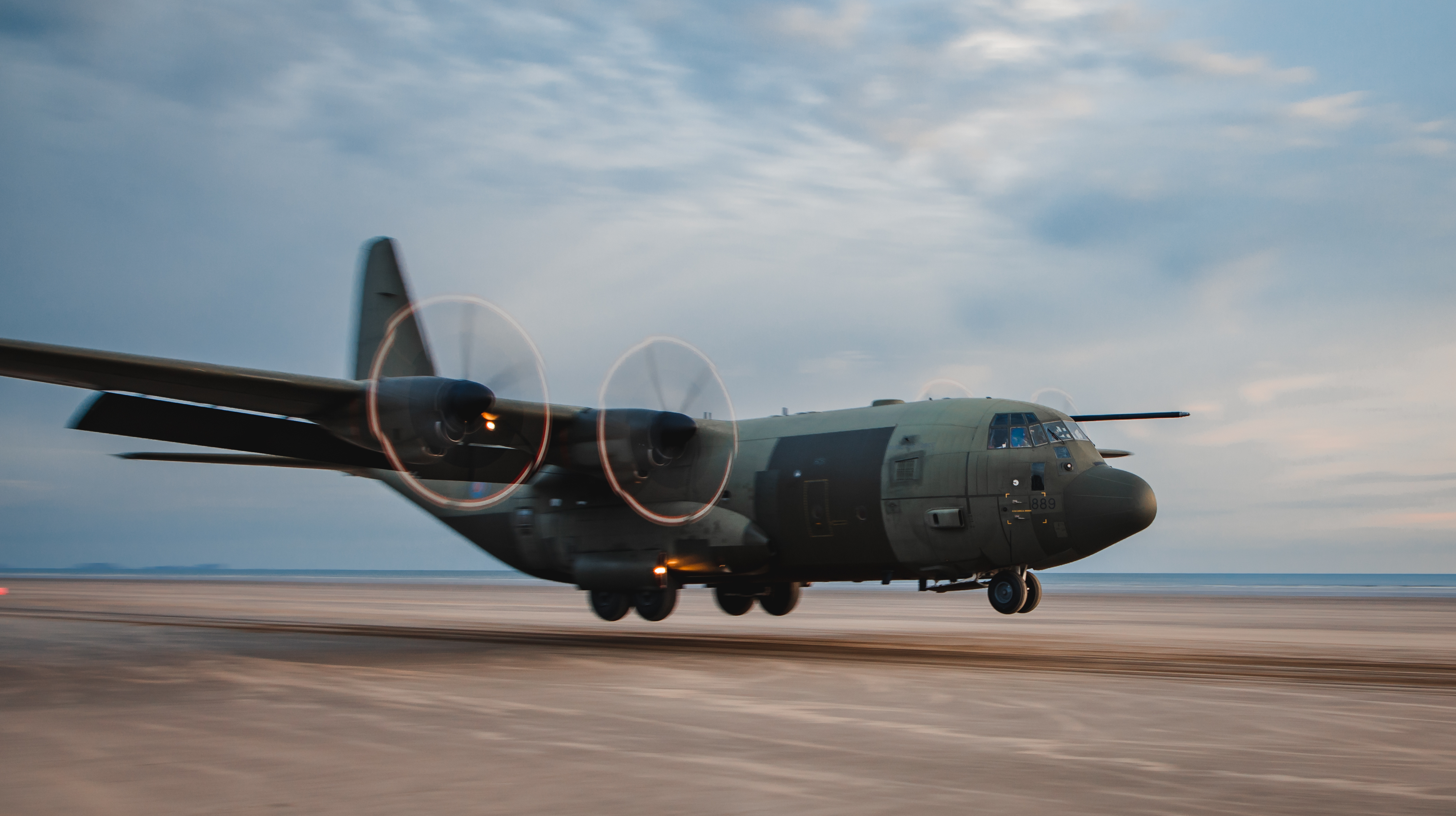 Image shows Hercules aircraft taking off.