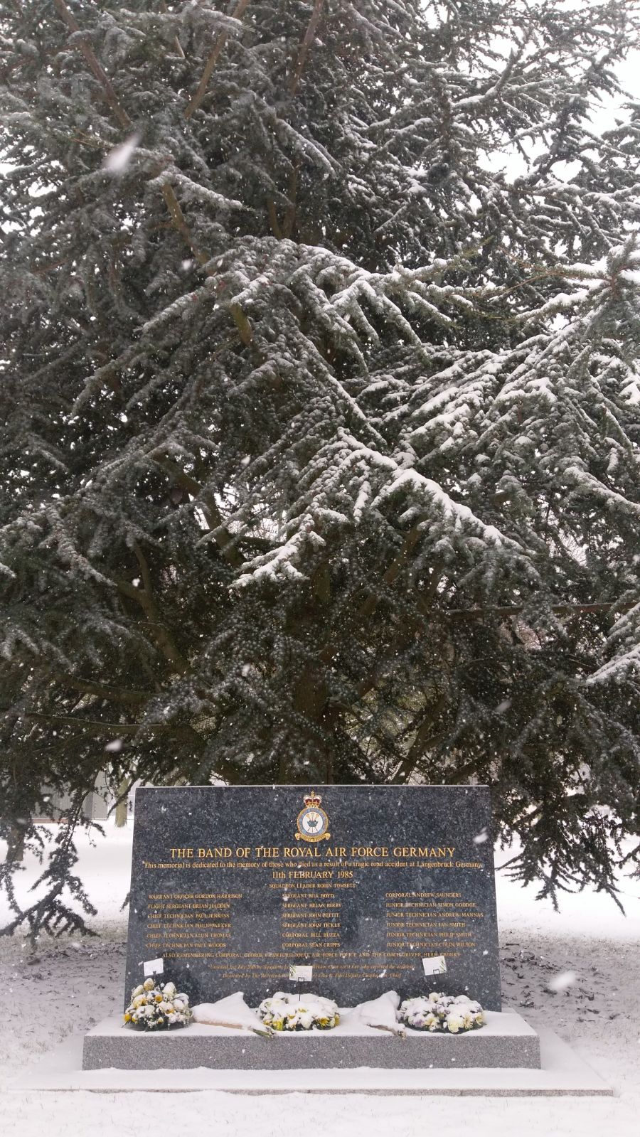 Memorial and wreaths covered in snow.
