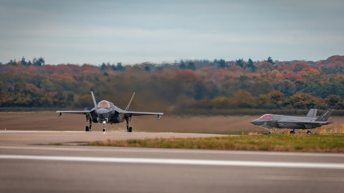 Image shows Lightning aircraft taxiing on airfield.