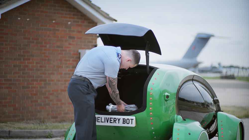 Image shows aviator takes load from boot of an electric car.