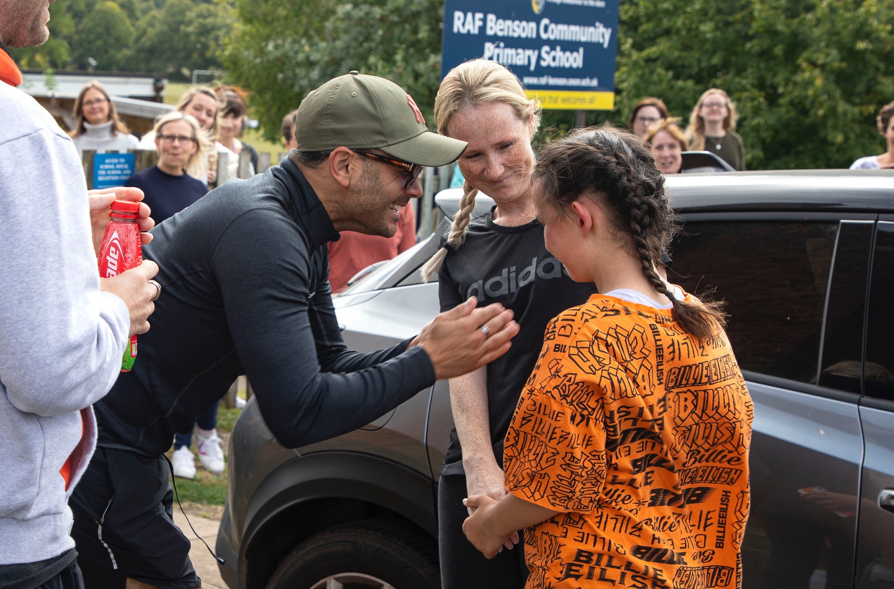 Katie meets Chris for the first time, watched by family, friends and teaching staff