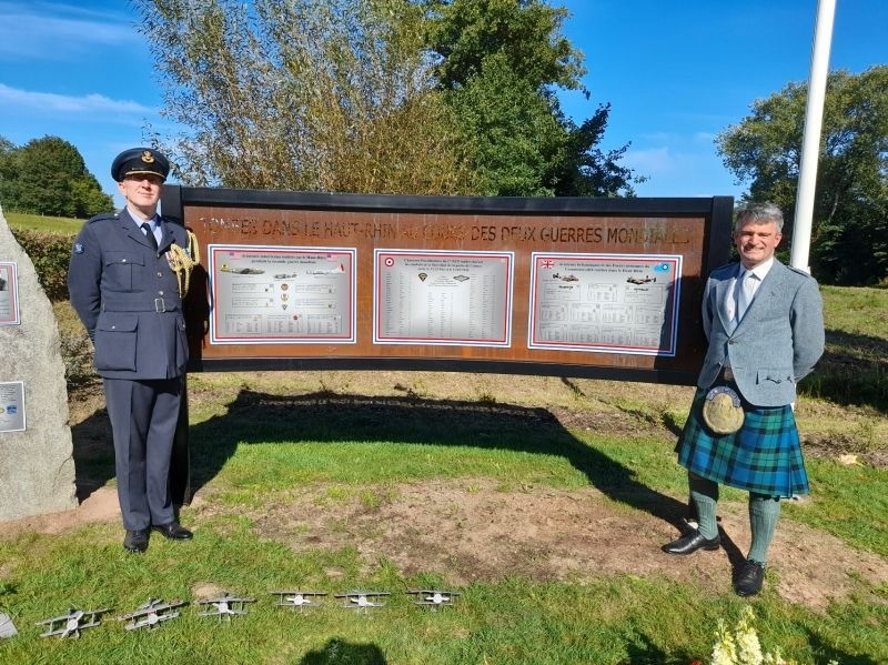 Personnel stand by memorial.
