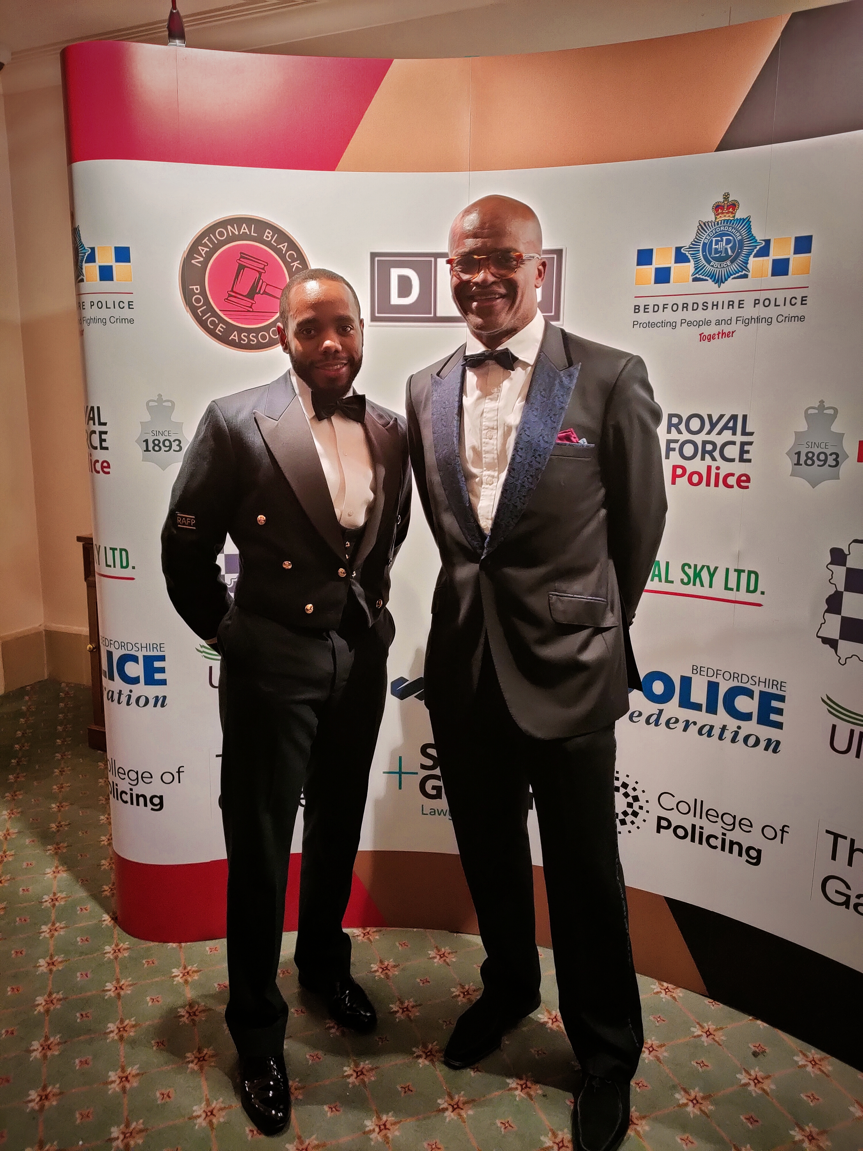 Personnel and Kriss Akabusi stand in front of board.