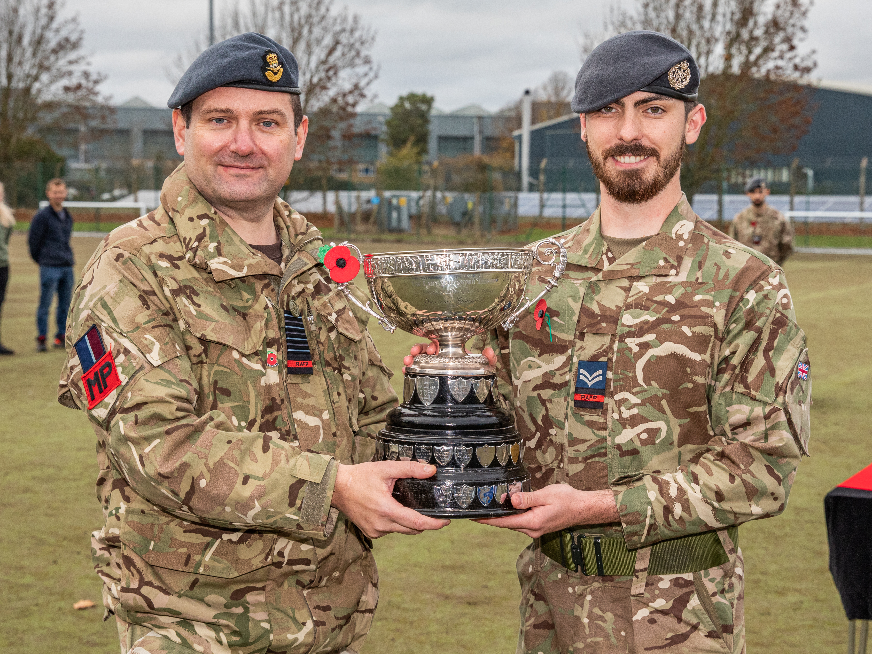 Image shows RAF Police shaking hands and accepting award.