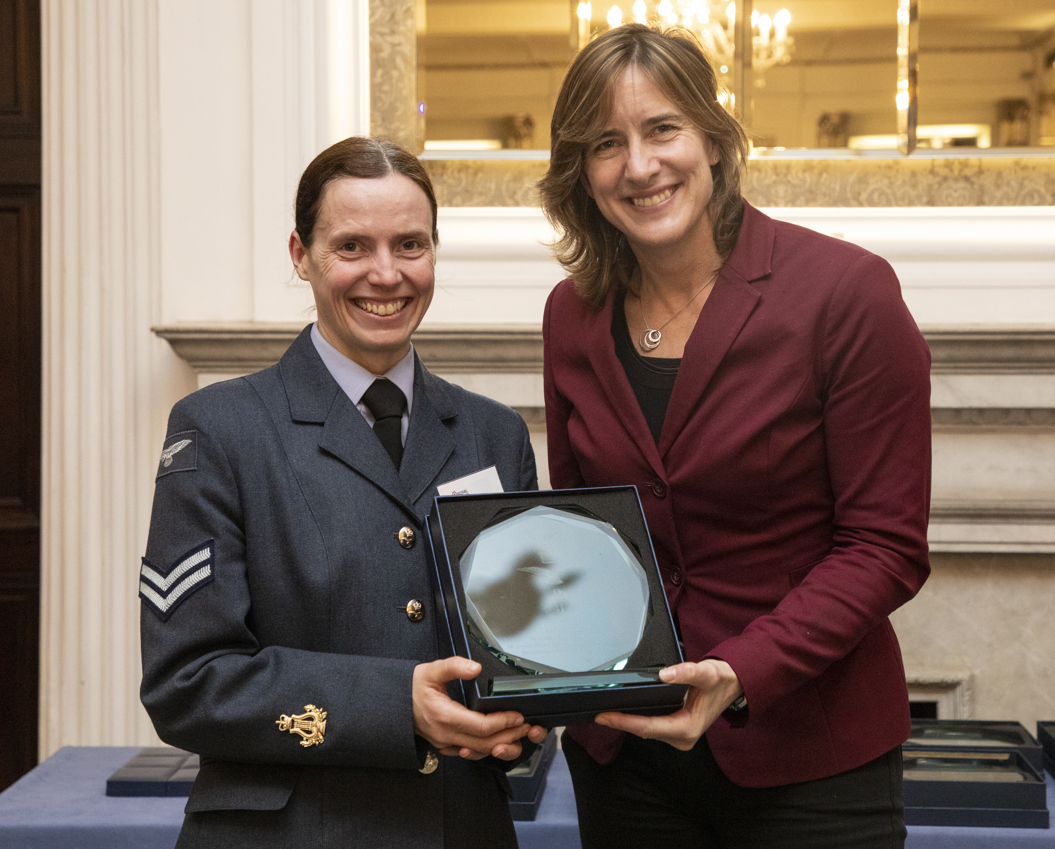 Caroline presents Shona with her award.