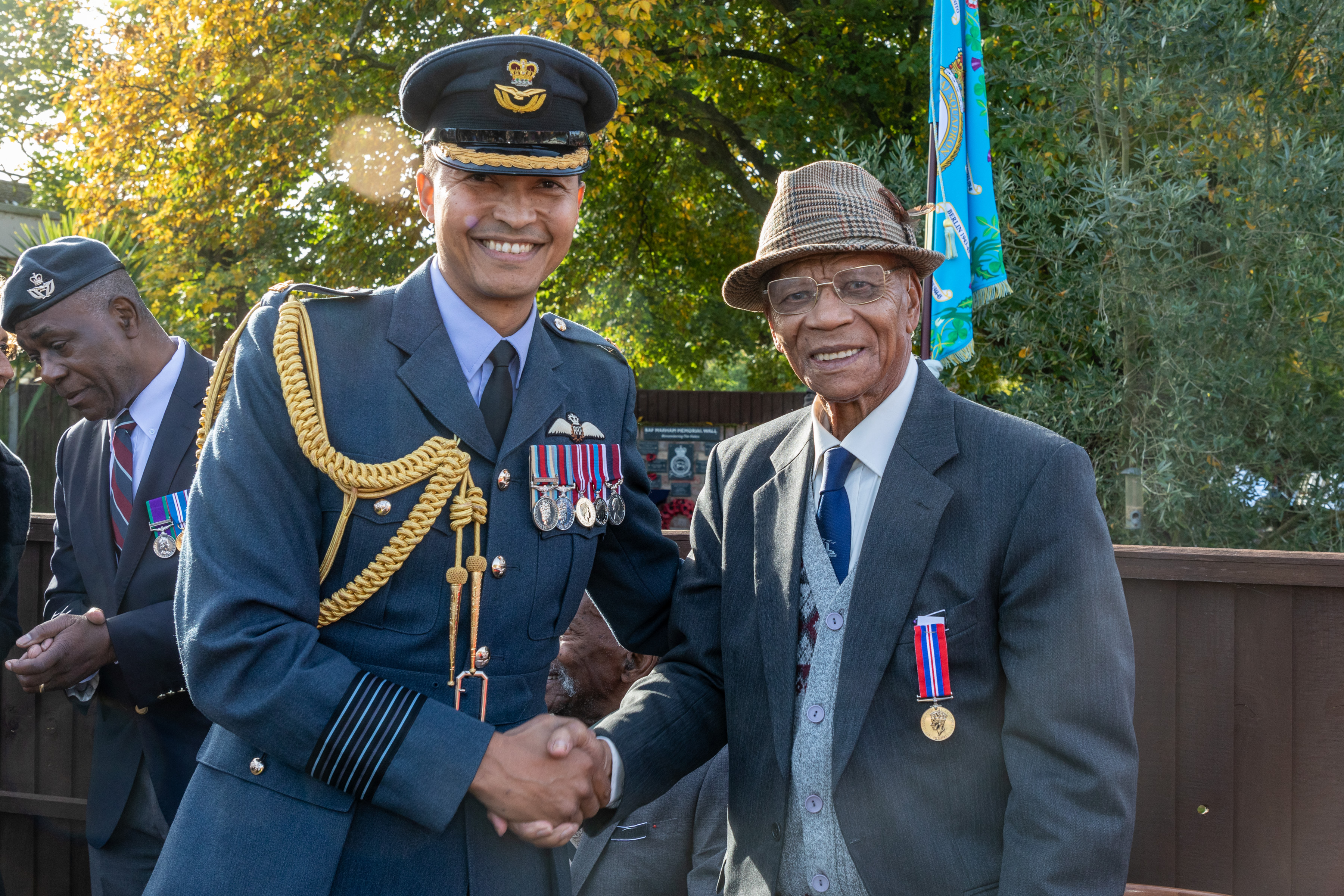 Image shows RAF Station Commander and veteran shaking hands.