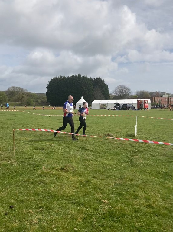 Orienteer runon grass.